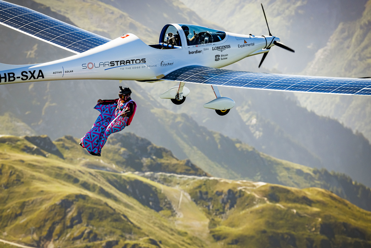 Swiss freeride snowboarder, base jumper and wingsuit pilot Geraldine Fasnacht jumps out of SolarStratos, a solar powered aircraft prototype, flown by Swiss adventurer Raphael Domjan to perform the first ever wingsuit jump from and electrical and solar airplpane, above the alpine resort of Verbier, Switzerland, Saturday, June 18, 2022.