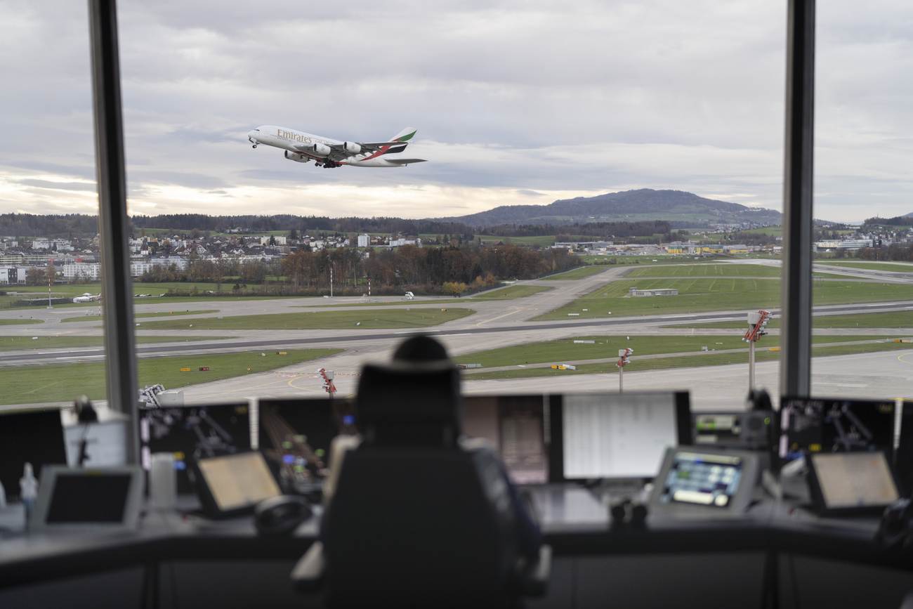 An aircraft is seen taking off from the point of view of a control center.