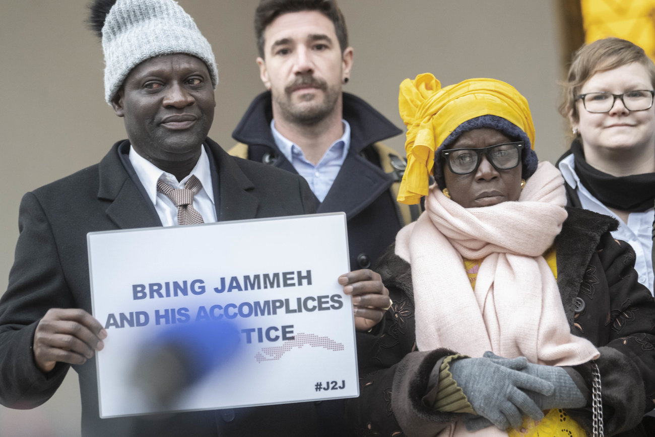 Victims and their relatives demonstrate outside the Swiss Federal Criminal Court in Bellinzona in canton Ticino, Switzerland, prior to the start of the trial against former Gambian Interior Minister Ousman Sonko on Monday, January 8, 2024.