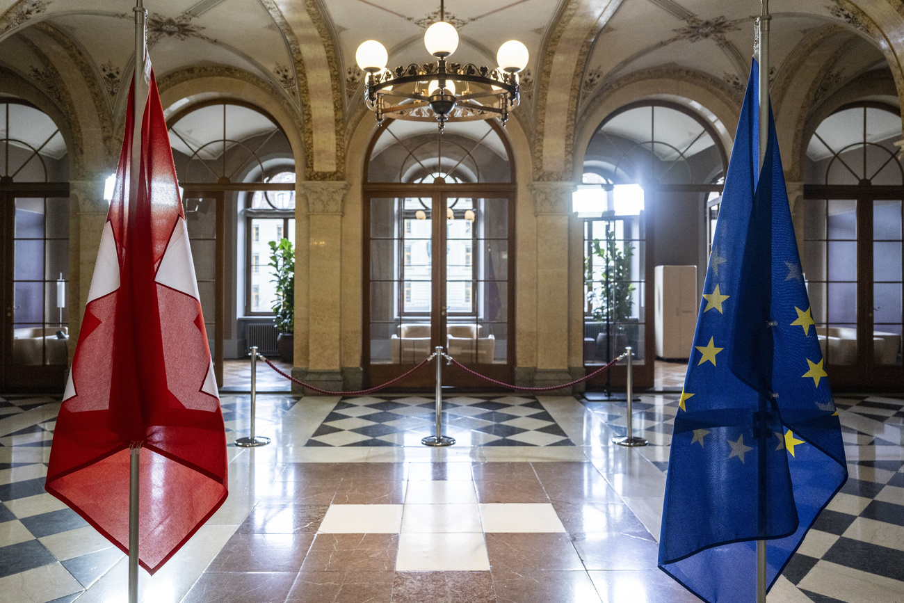 A Swiss, left, and a EU flag, right, stand in the government building during the courtesy visit from Didier Reynders, European Commissioner for Justice, in Bern, Switzerland.