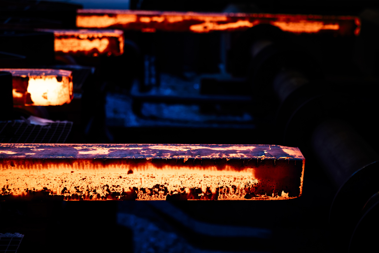 A set of rectangular steel bars so hot they're still glowing.