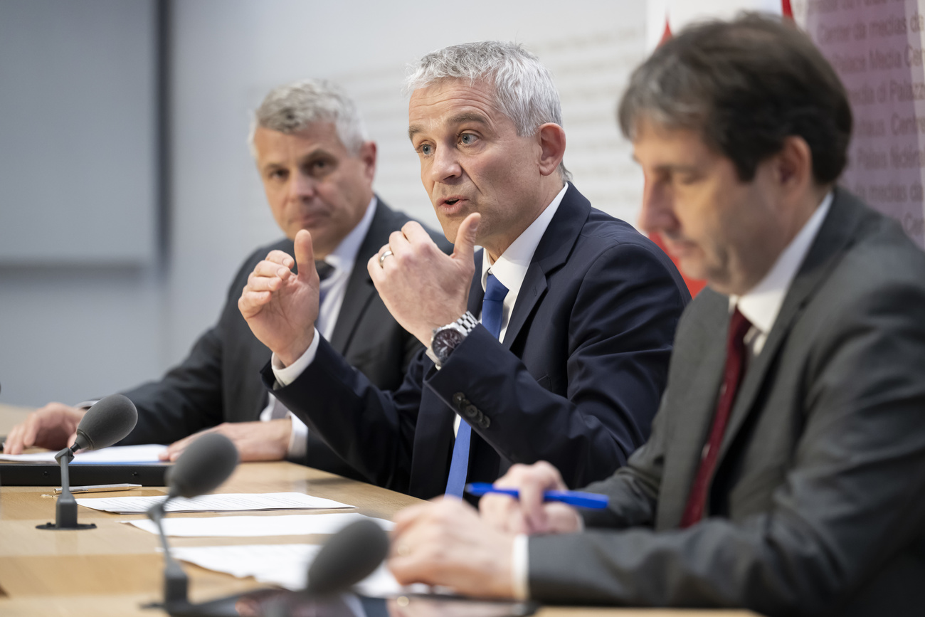 Federal Councillor Beat Jans, center, speaks alongside Cantonal Councillor Christoph Ammann, Head of the Canton of Bern Department of Economic Affairs, Energy and the Environment, left, and Vice Chancellor Andre Simonazzi, Federal Council Spokesman, right, at a media conference on measures to increase the integration of persons with protection status S into the workforce, at the Federal Palace Media Center in Bern on Wednesday, May 8, 2024.