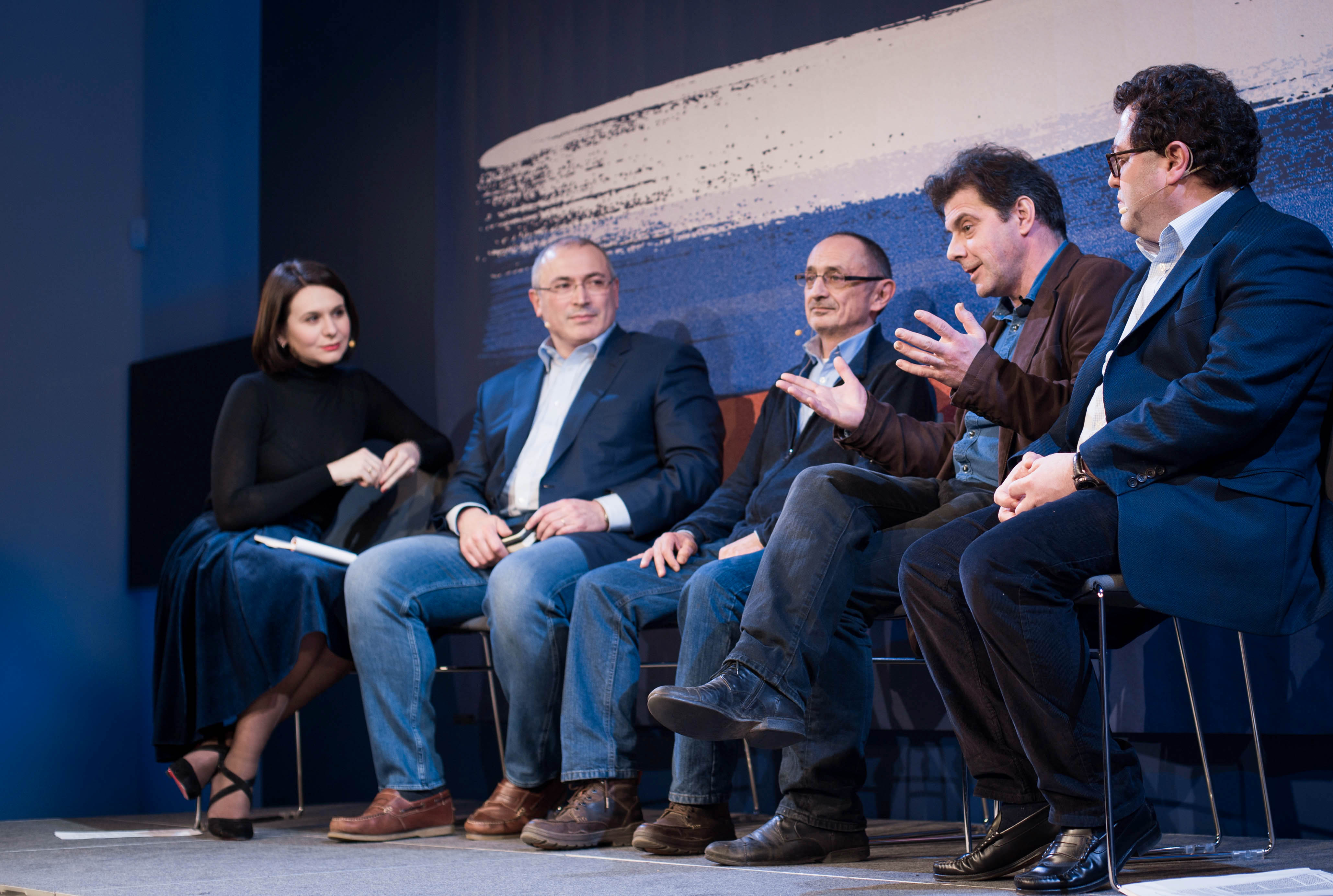 الصحفية إيلينا سيرفيتاز تدير مناقشة في لندن مع ميخائيل خودوركوفسكي (الثاني من اليسار)، والعالمين في مجال العلوم السياسية ألكسندر موروزوف (في الوسط) وكيريل روجوف (الثاني من اليمين)، والصحفي في مجلة الإيكونوميست أركادي أوستروفسكي (على اليمين).