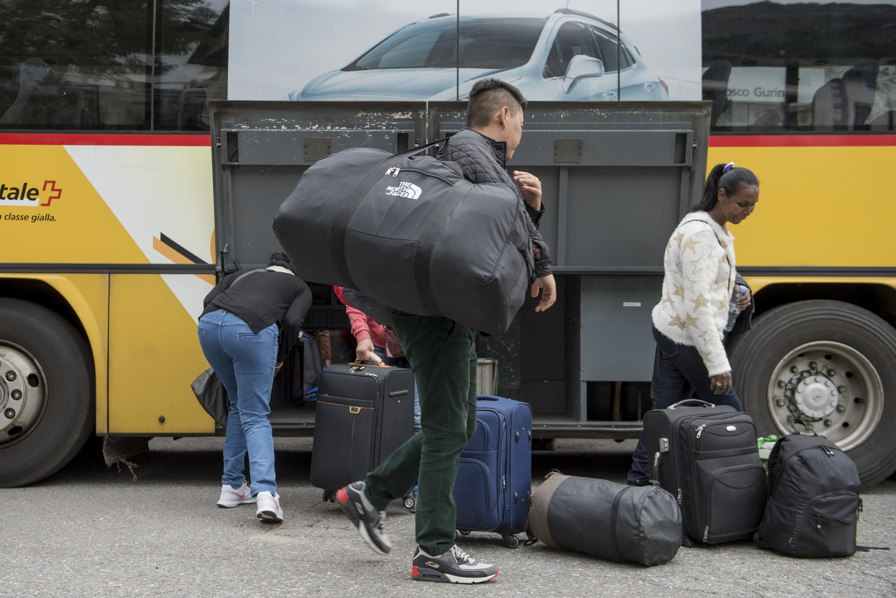Profughi eritrei scendono da un bus della Posta.