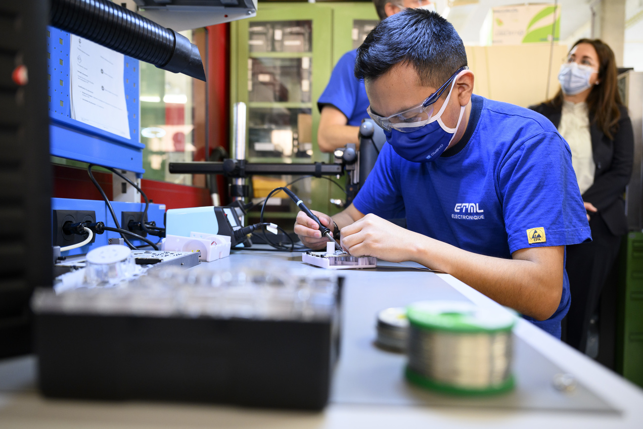 A trainee electronics technician assembles an educational robot in a workshop at the Ecole Technique - Ecole des Metiers de Lausanne (ETML) on February 7, 2022.