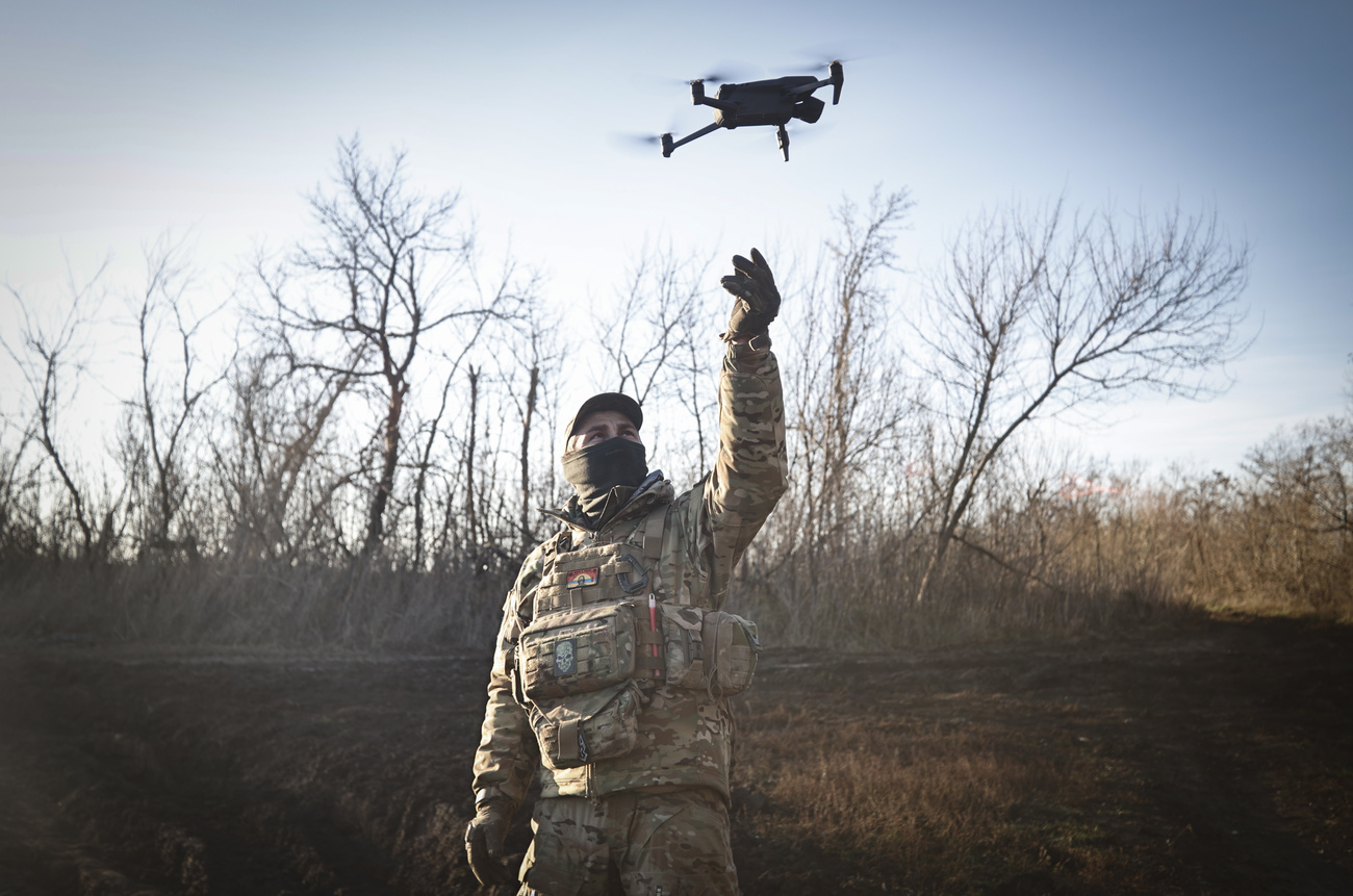 A Ukrainian serviceman flies a drone during an operation against Russian positions at an undisclosed location in the Donetsk region, Ukraine, Sunday, Dec. 4, 2022. (KEYSTONE/AP Photo/Roman Chop)