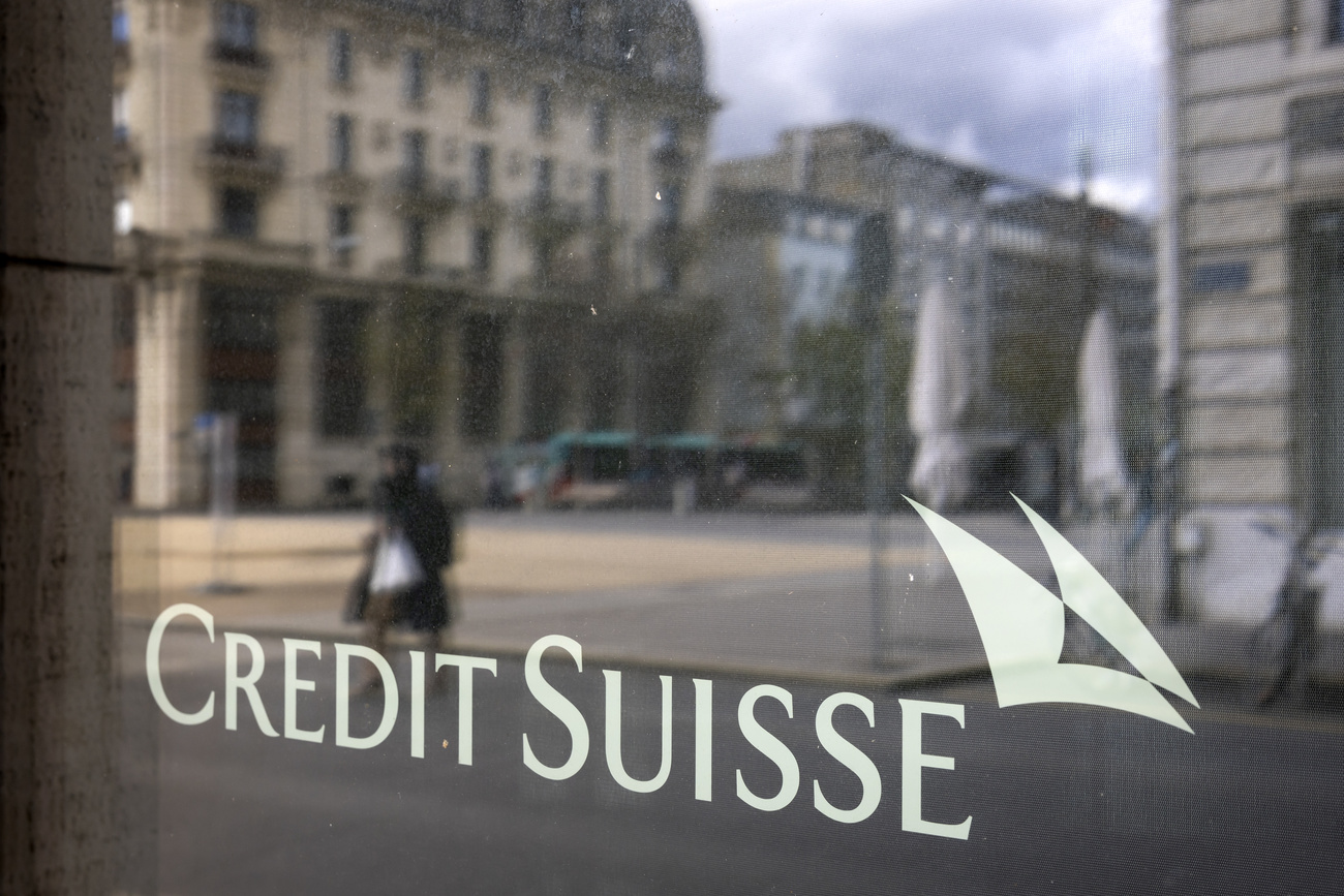 The Credit Suisse logo is seen on the windowfront of a bank location in Biel/ Bienne with the reflection of the street and otherbuildings