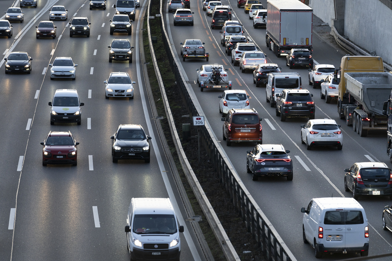 a section of the A1 motorway is almost filled with cars and trucks moving in both directions
