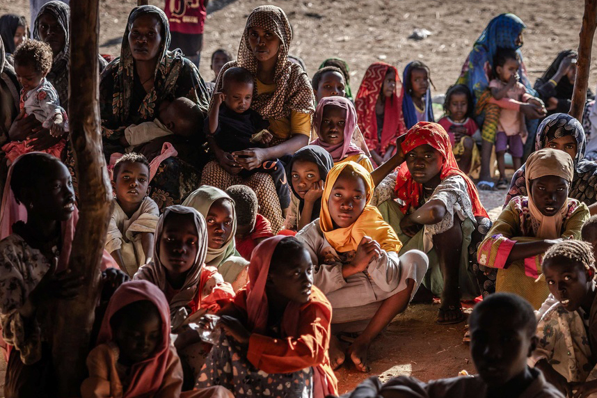 A group of people sitting on the ground