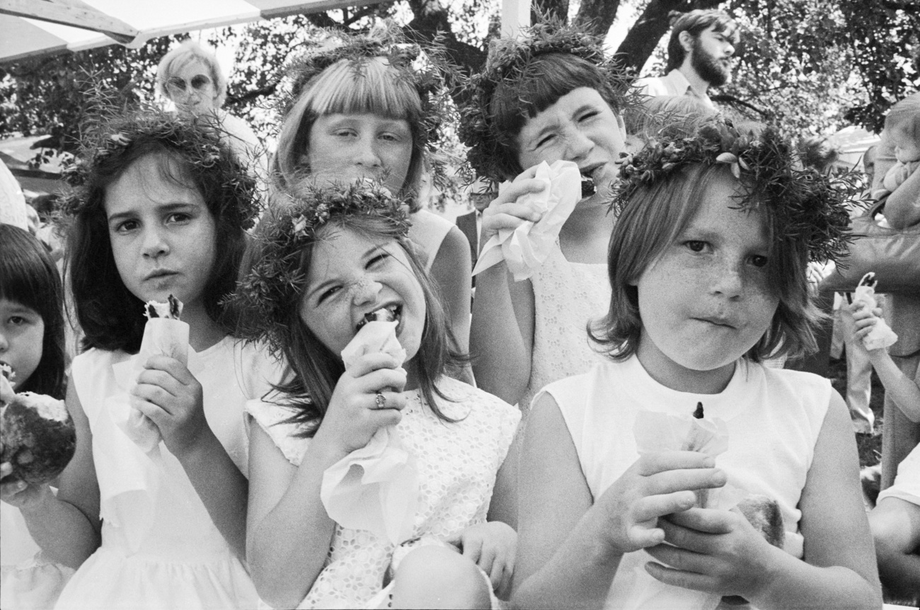 Children eating sausages