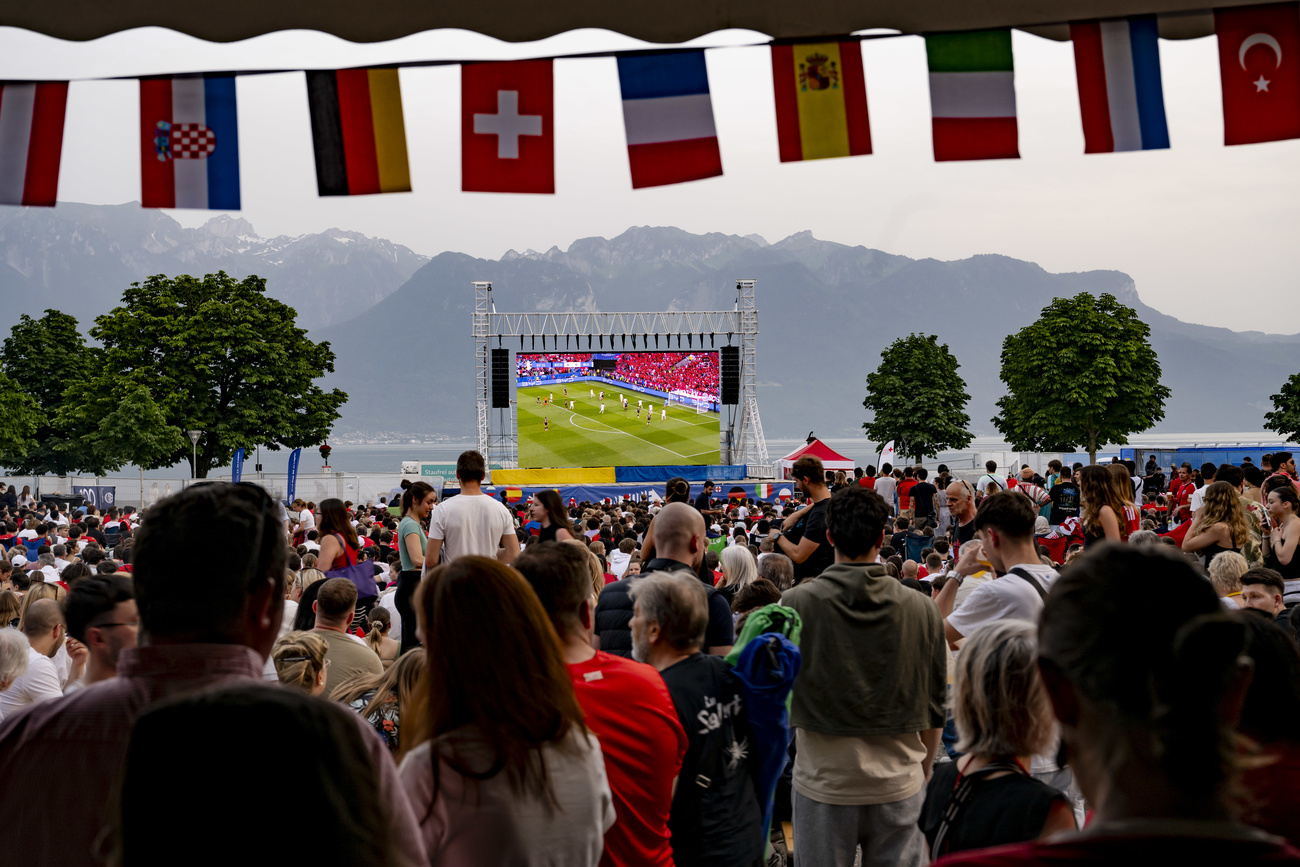 Swiss supporters cheer for their team in the fan zone for the match between Scotland and Switzerland during the UEFA Euro 2024 football championships at the public viewing in Vevey, Switzerland, Wednesday, June 19. 2024.