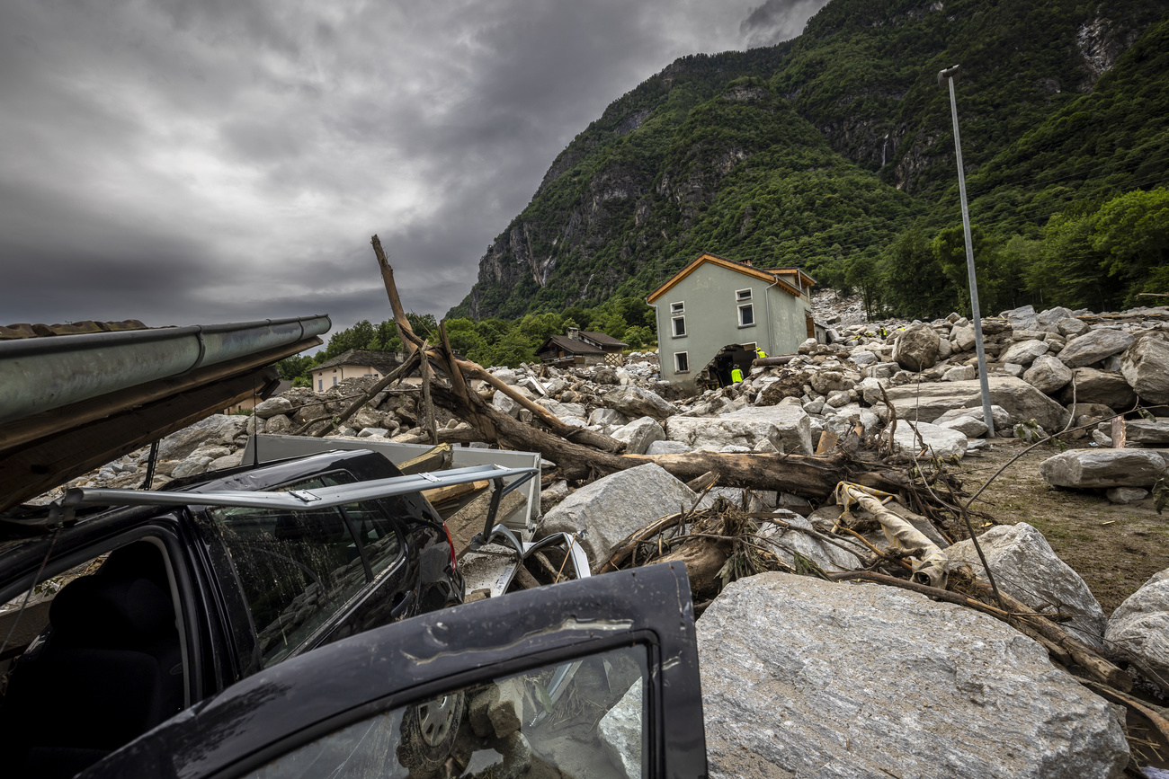 Rescue workers inspect the site of a landslide, caused by severe weather and heavy rain in the Misox valley, in Sorte village, Lostallo, southern Switzerland on Sunday June 23, 2024. Massive thunderstorms and rainfall led to a flooding situation with large-scale landslides on Friday evening in the Misox valley, south-eastern Switzerland. One person was found dead and two others were still missing on Sunday. (KEYSTONE/Michael Buholzer)