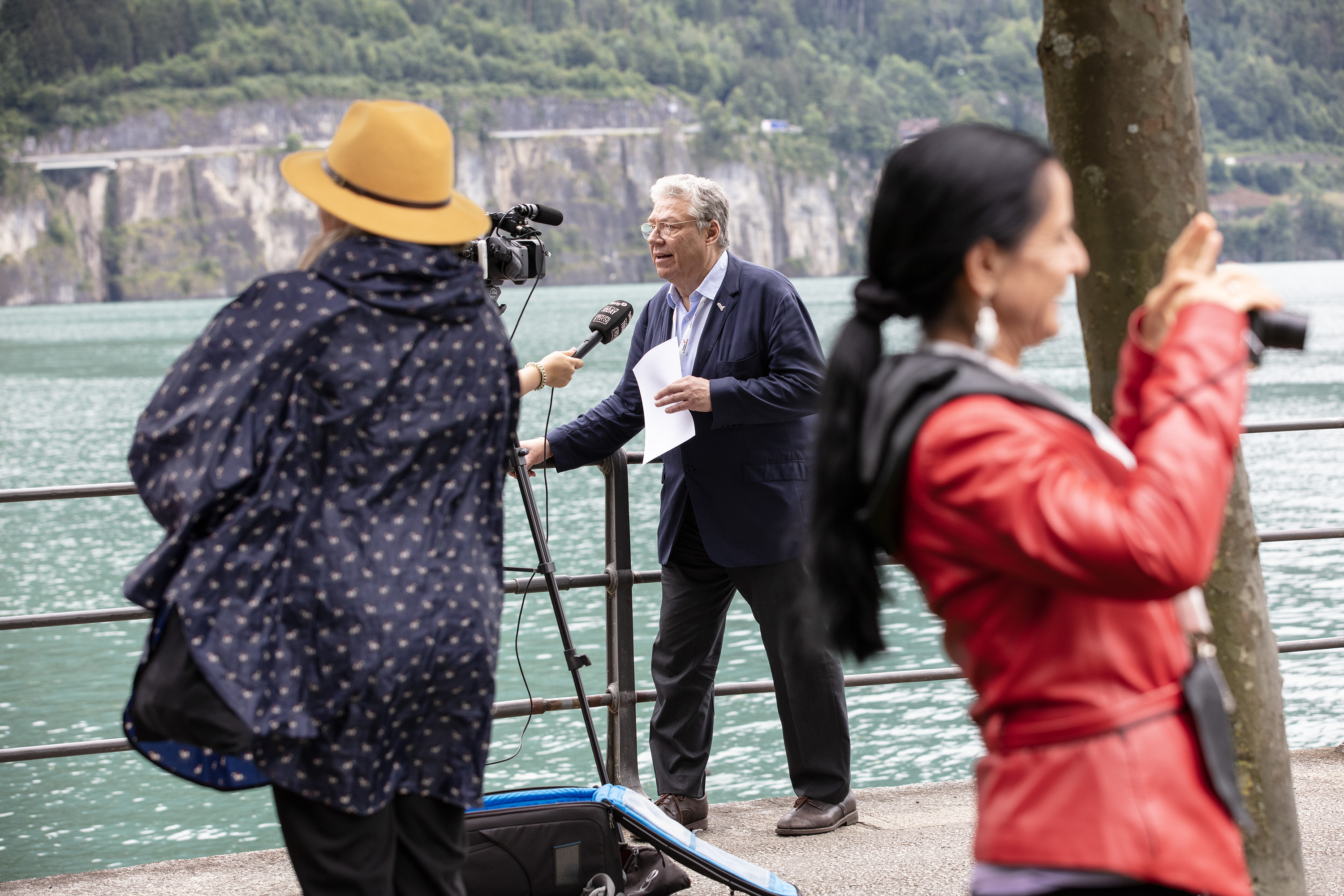 OSA President Filipo Lombardi gives an interview to a local journalist on the lakeside promenade at the edge of the Swiss Abroad square.