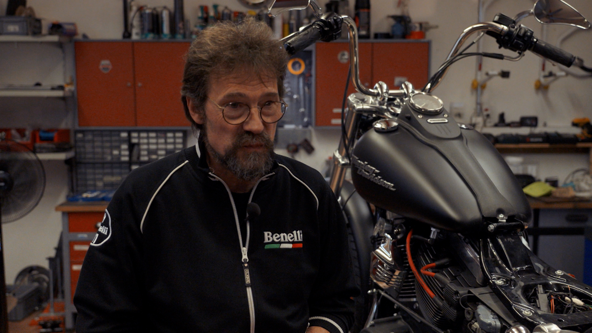 man in a motorbike workshop