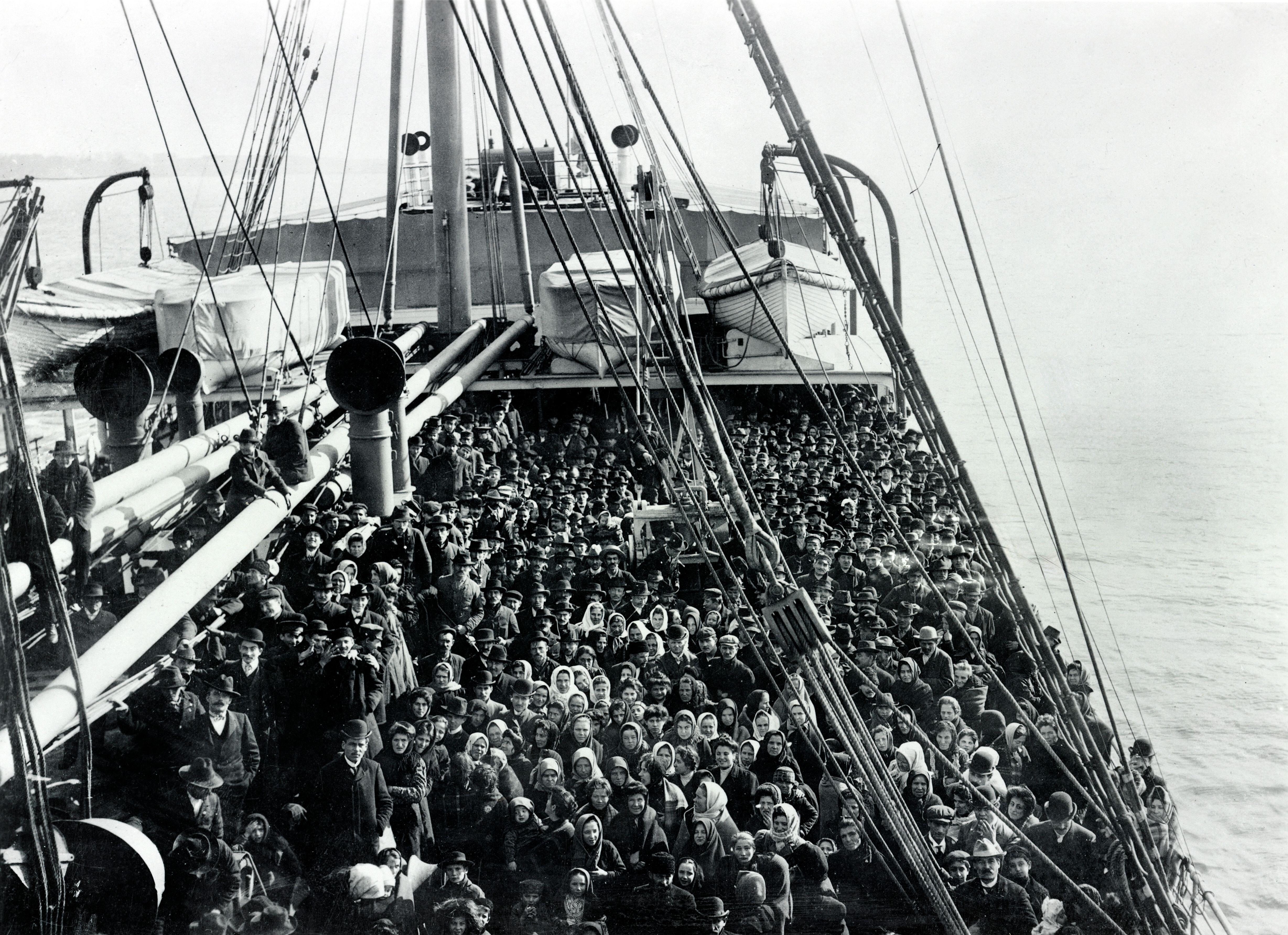 Schwarz-Weiss-Foto, Gruppe von Auswanderern auf dem Deck eines Schiffes