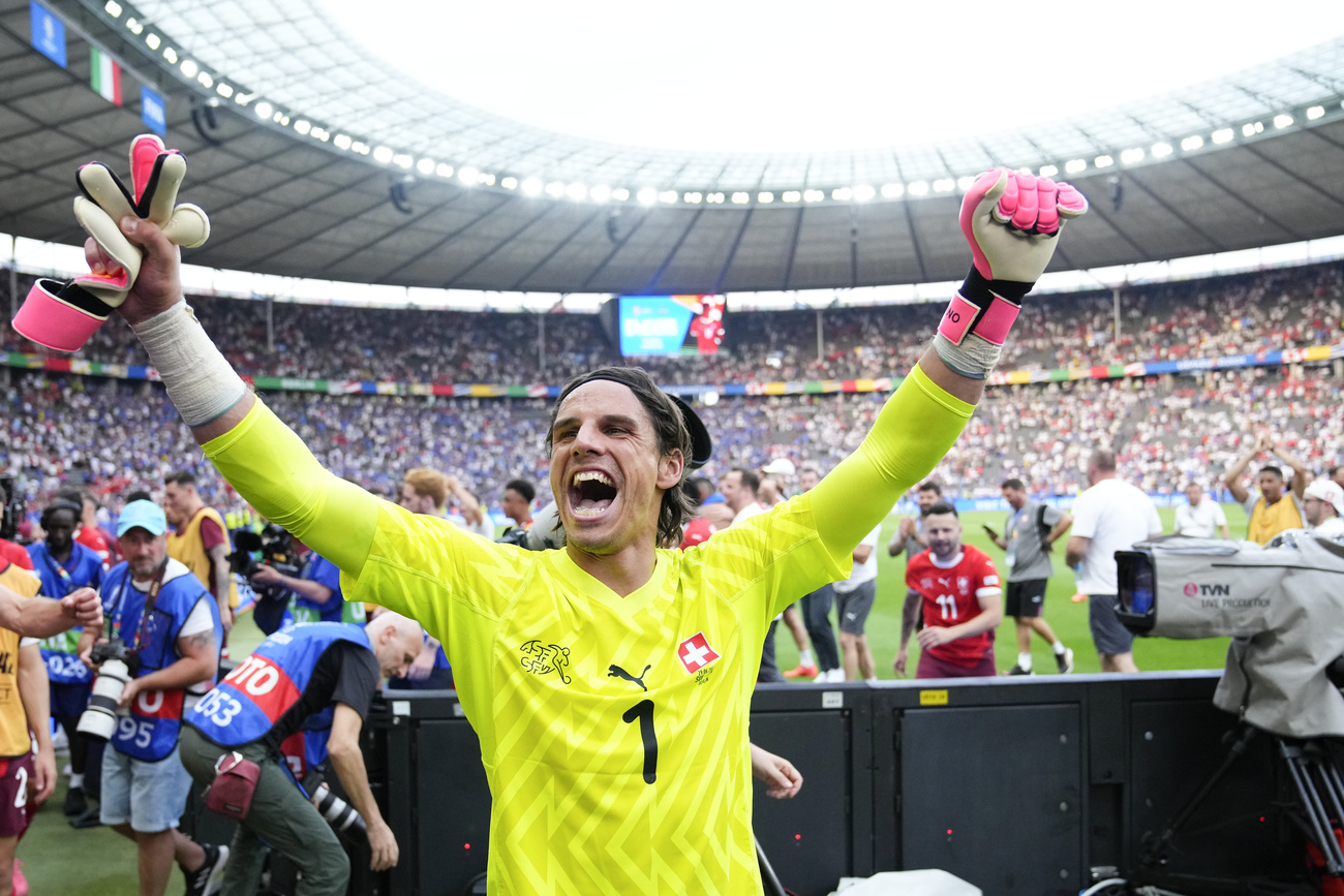 calciatore che gioisce con le mani al cielo