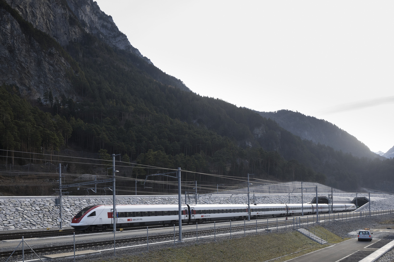 Un treno passeggeri esce sfrecciando dalla galleria in direzione nord.
