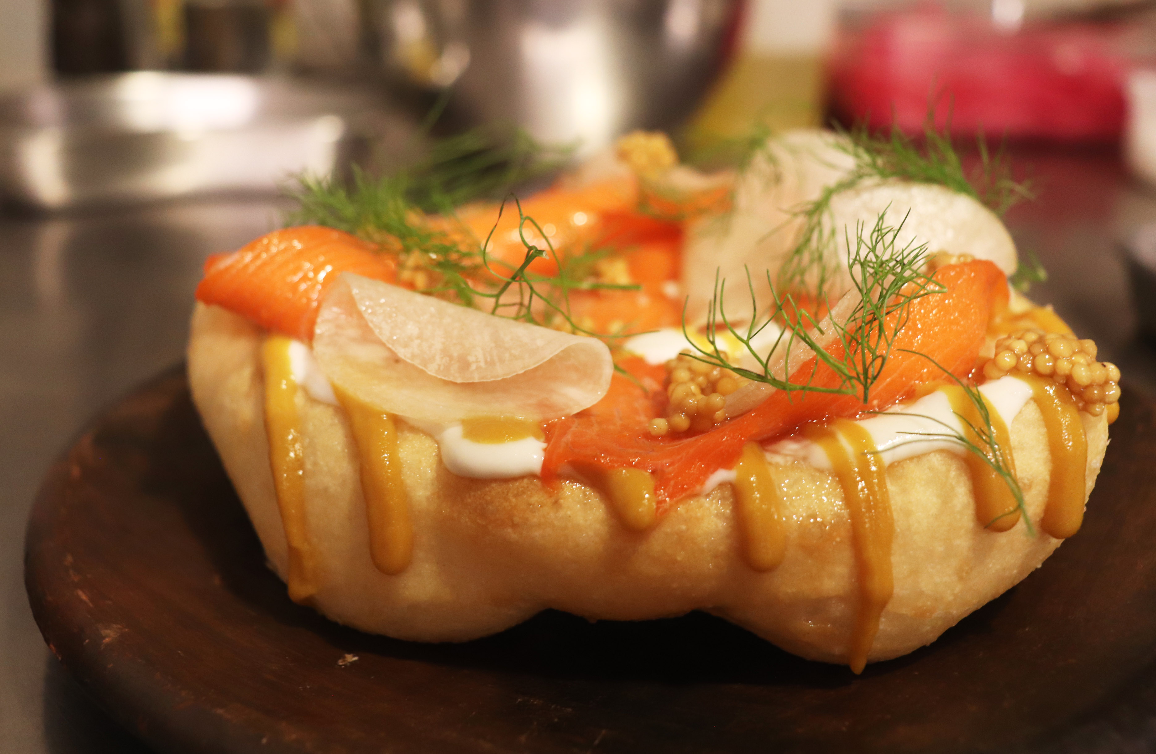 Hungarian langos with fish and mustard sauce.