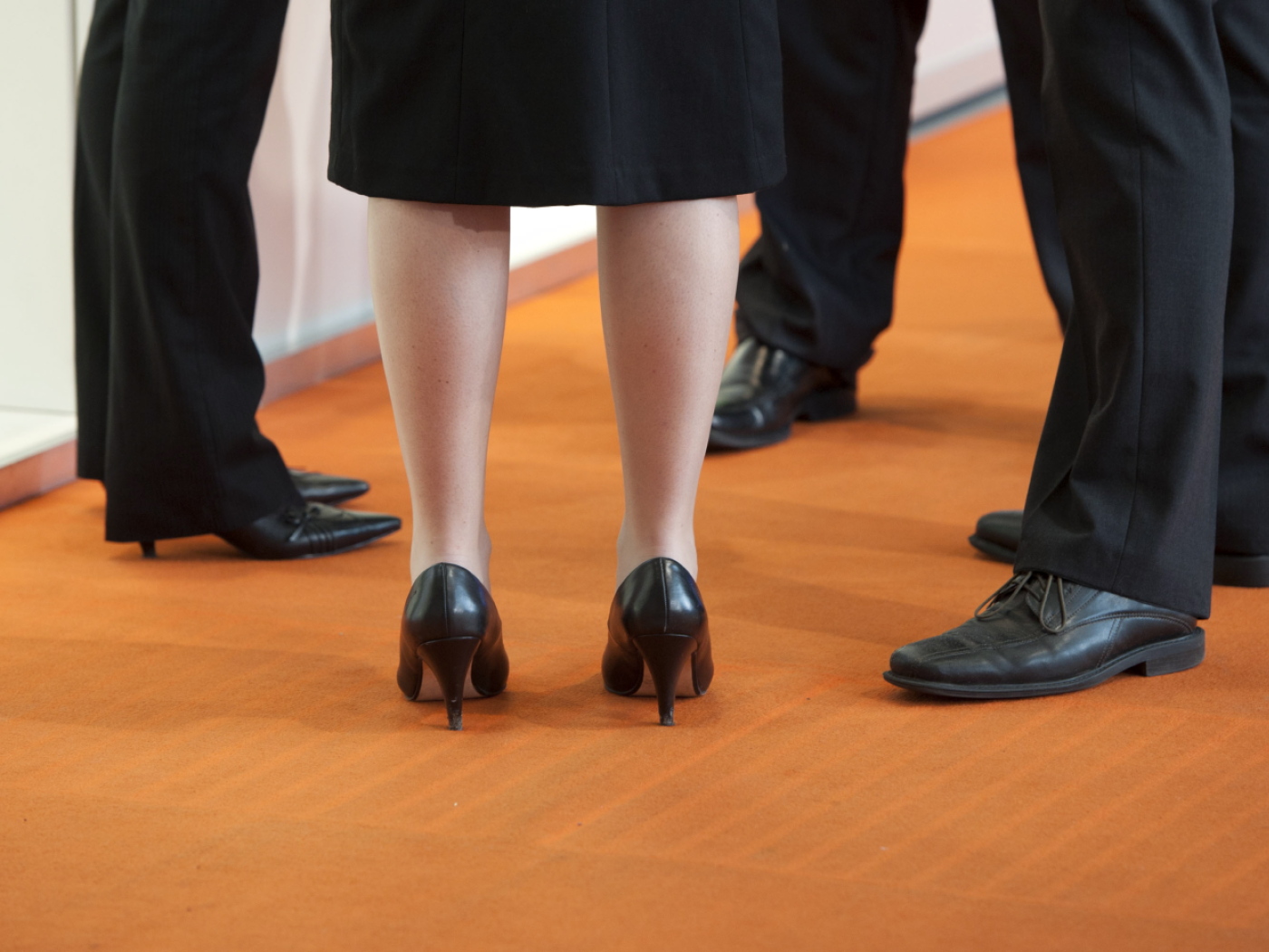 A woman and three men in professional attire