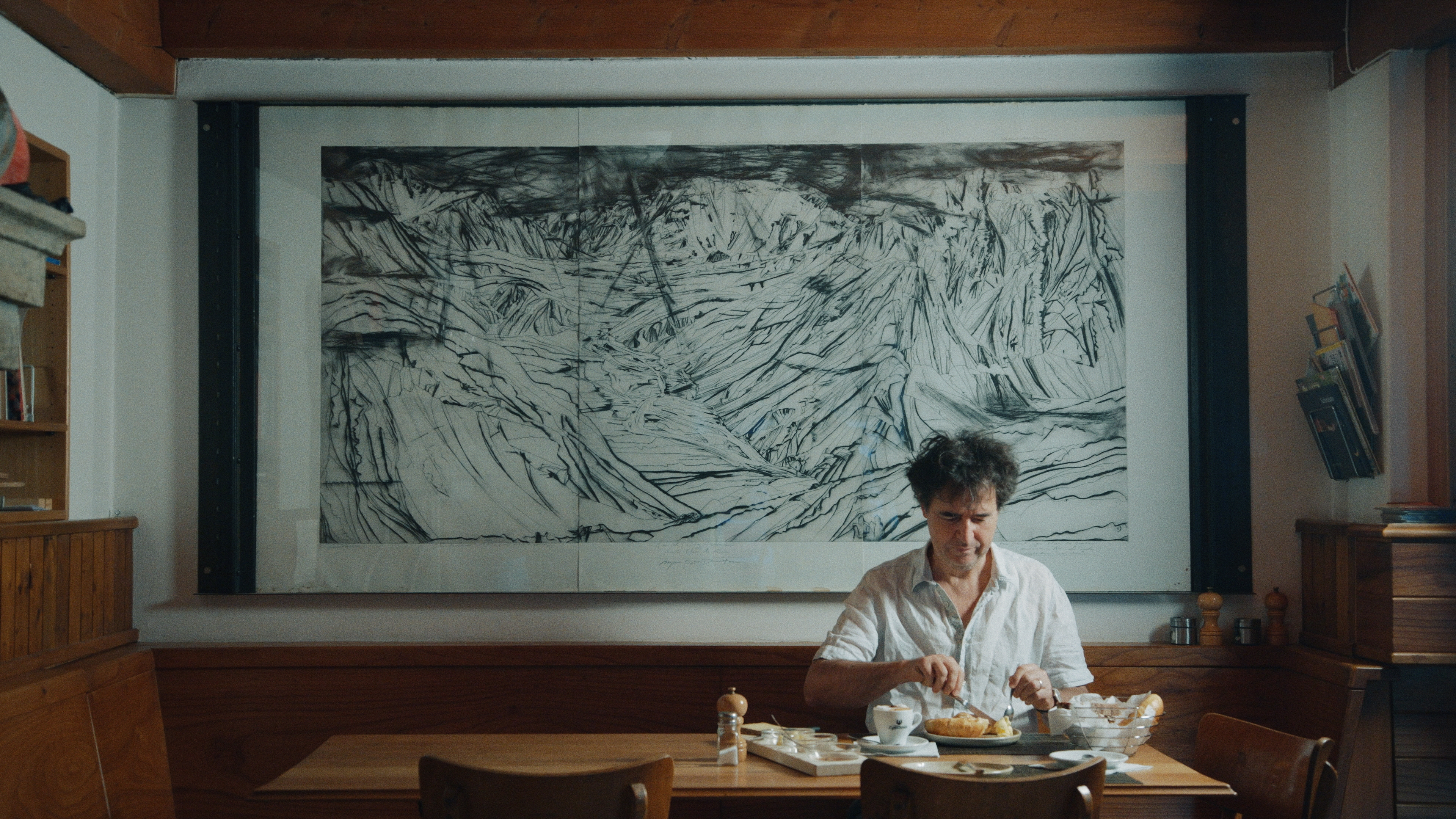 Patrick Thurston in front of his father's three-part Greina triptych in Olivone, canton of Ticino.