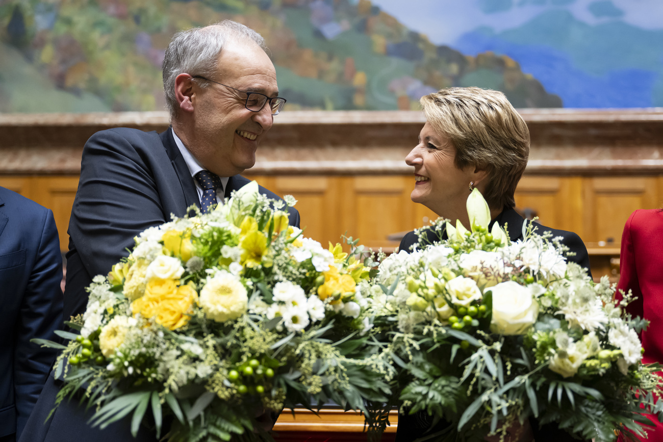 Newly elected President Karin-Keller Sutter, right, and newly elected Vice-President Guy Parmelin, left, receive applause after their election by the United Federal Assembly during the winter session of the Federal Assembly in the National Council in Bern on Wednesday, 11 December 2024.