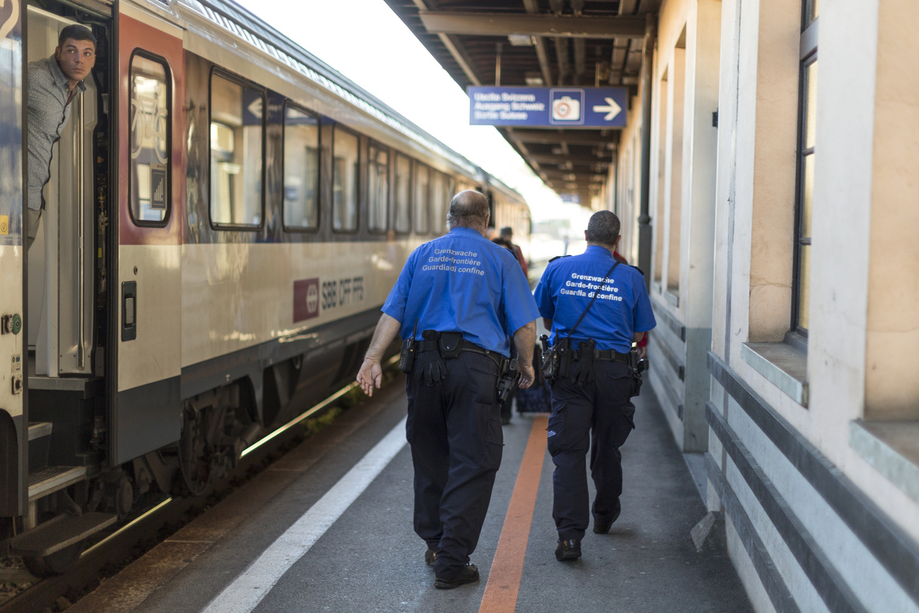 Members of the Swiss Border Guard check a train at Chiasso railway station.