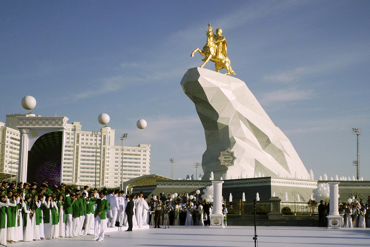 a statue of President Gurbanguly Berdymukhamedov atop a horse mounted on a towering pile of marble.