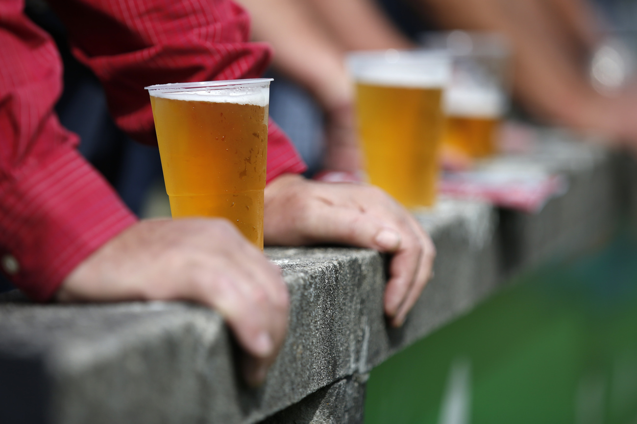 Full beer cups stand on the ledge in front of the spectators during the Swiss Cup 1/16 final football match