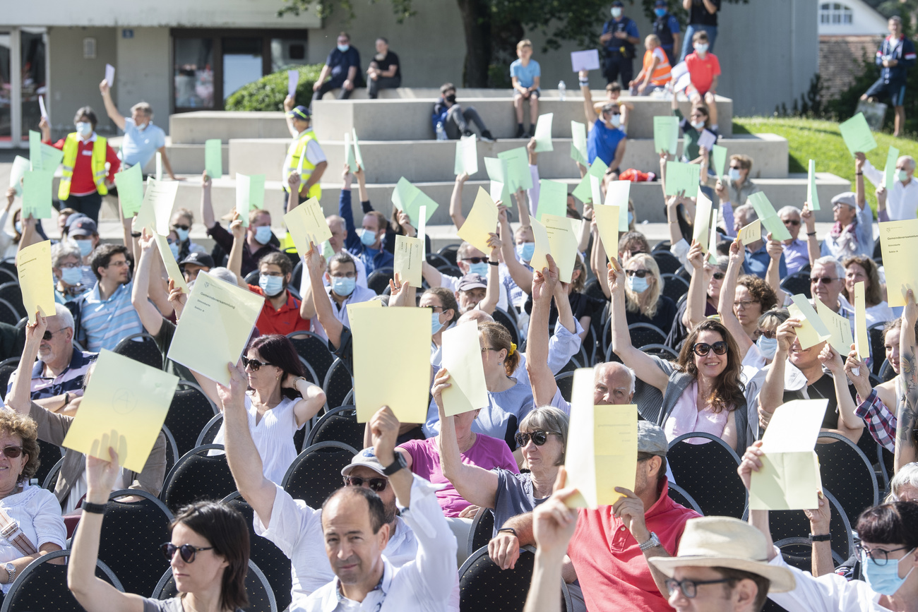 people holding up voting papers outside