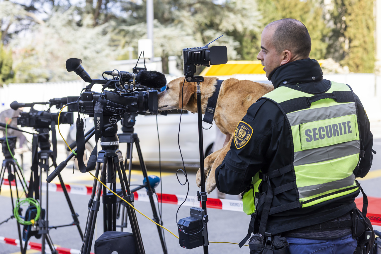 An UN security guard with his dog Miss check the journalists' equipment during the informal 5+1 Meeting on Cyprus, in Geneva, Switzerland, Tuesday, March 18, 2025. The informal 5+1 meeting on Cyprus, which is being held on March 17 and 18, in the context of the Secretary General's good offices efforts on the Cyprus issue. (KEYSTONE/Salvatore Di Nolfi)
