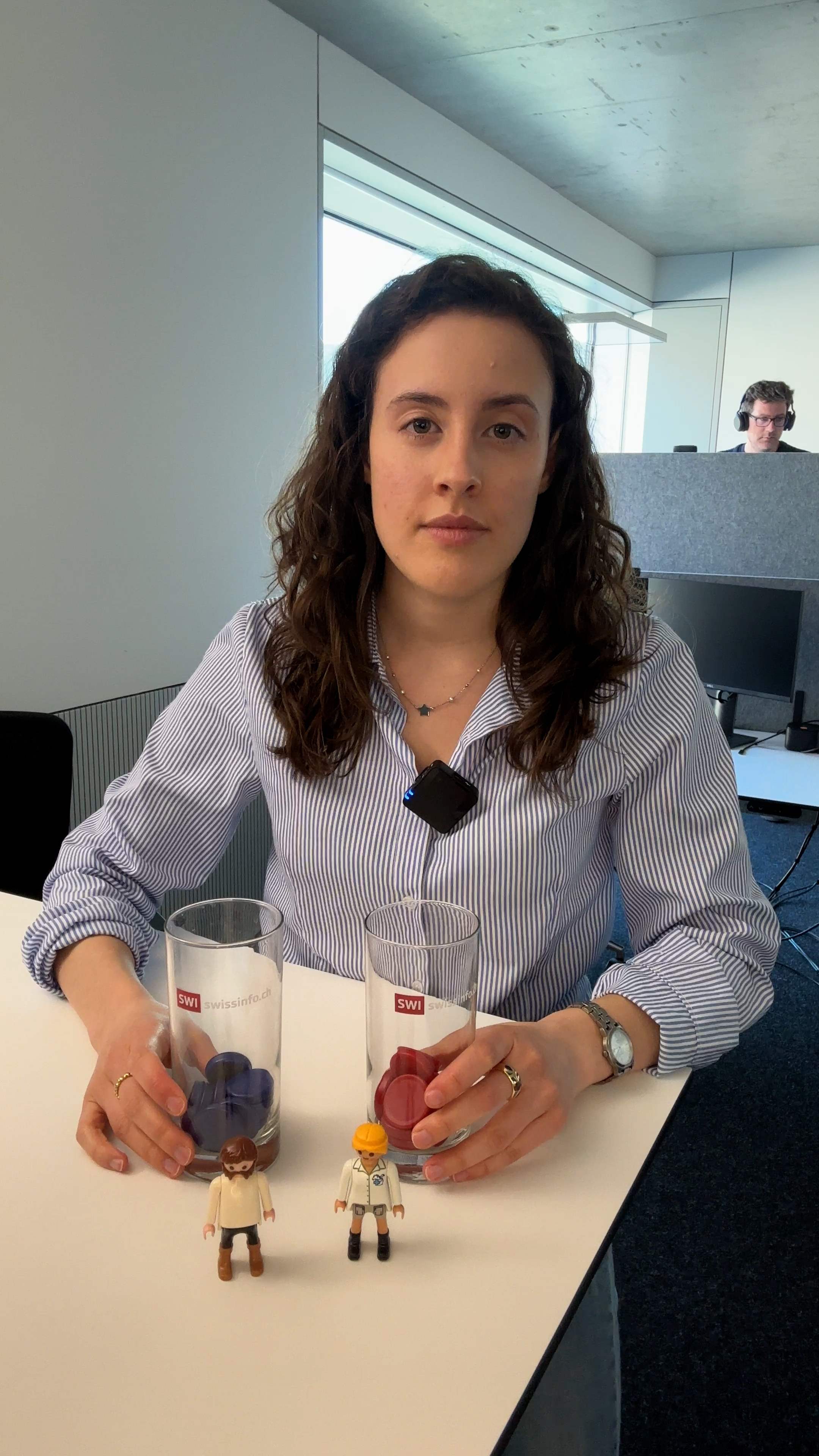 Photo of a woman in front of a desk with lego in front of her