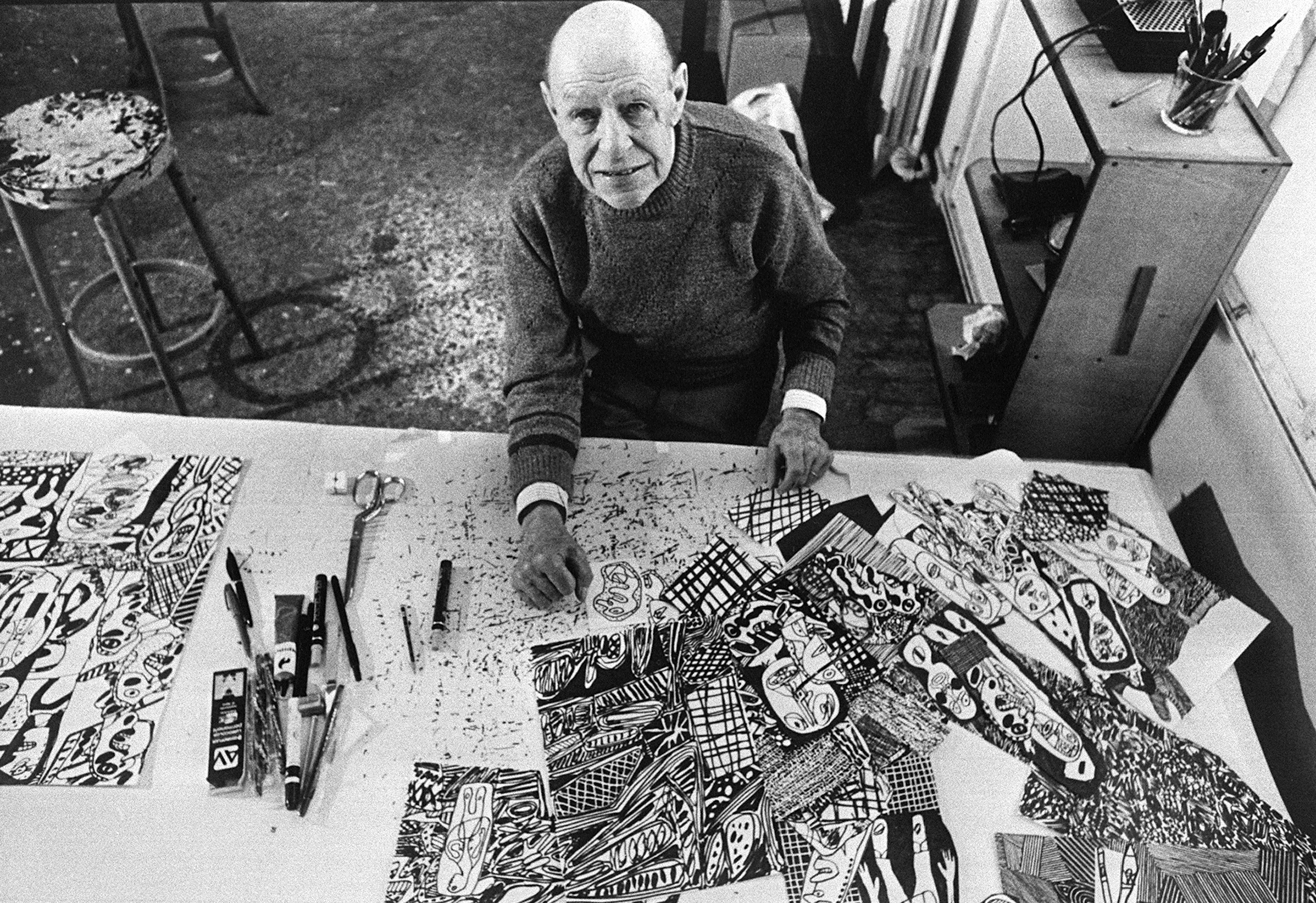 Jean Dubuffet shows some of his works in his Paris studio, 1976.