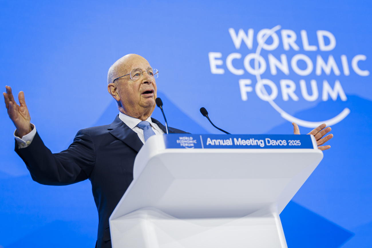 Photo of man speaking in front of WEF panel