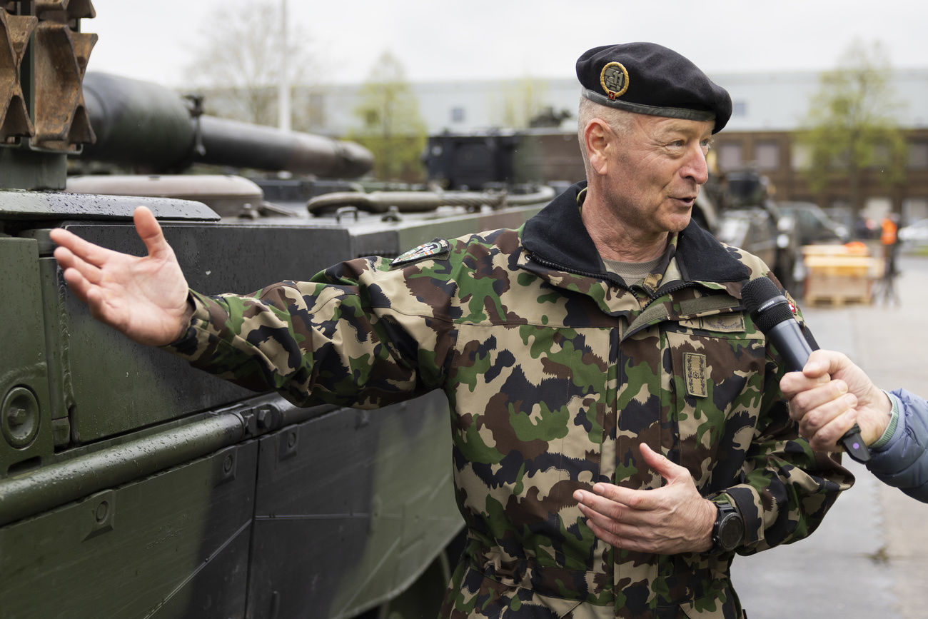 Brigadier parlant à la presse devant un char