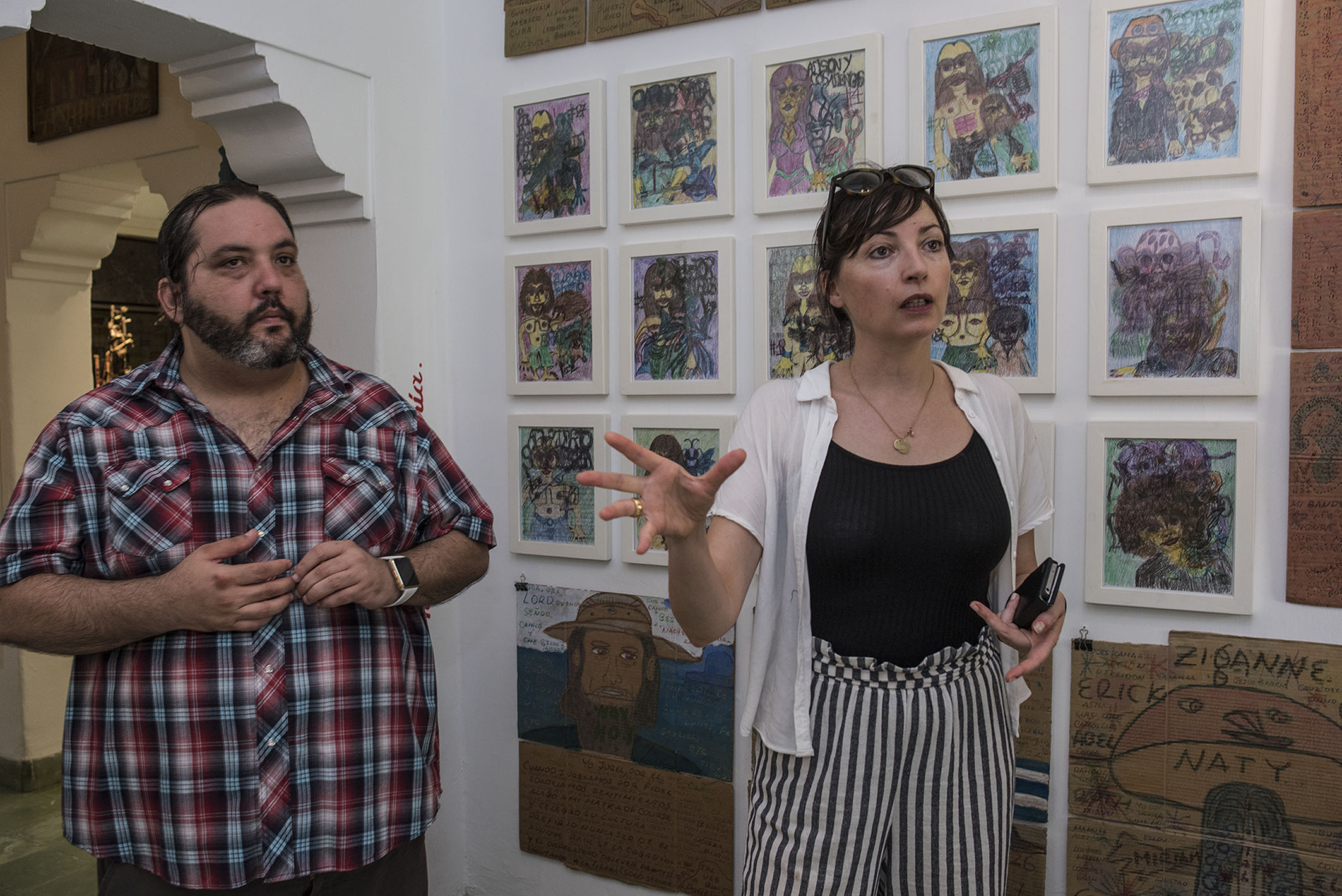 Samuel Riera (left) with the director of Collection de l'Art Brut Sarah Lombardi during her scouting trip to Riera Studio in Havana, October 2017.