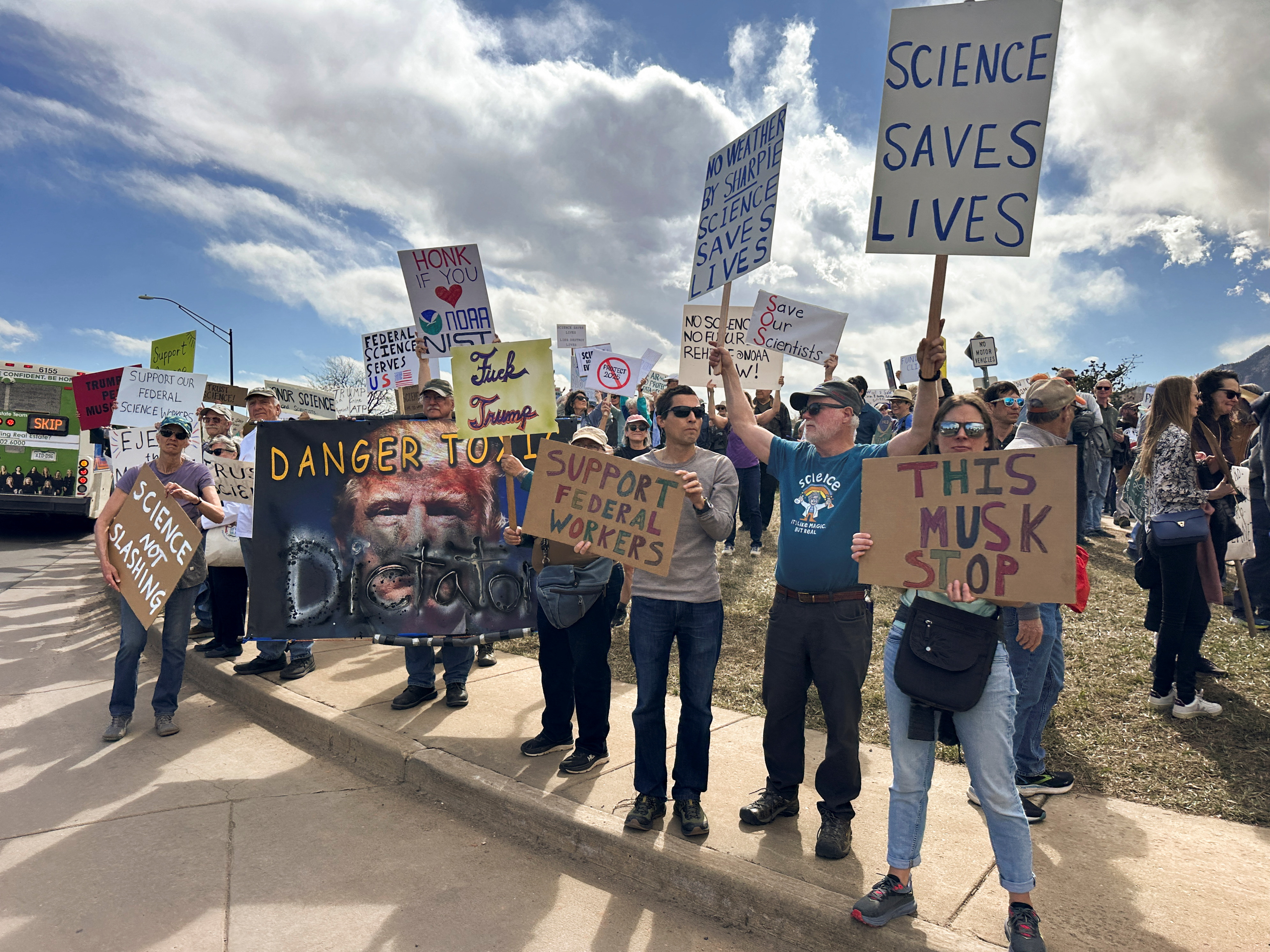 Protesters gather outside a National Oceanic and Atmospheric Administration building, to decry the Trump administration's layoffs of NOAA workers, in Boulder