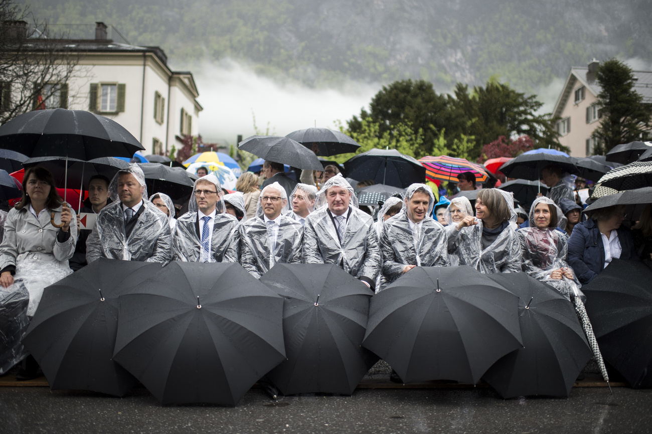 people sitting behind umbrellas