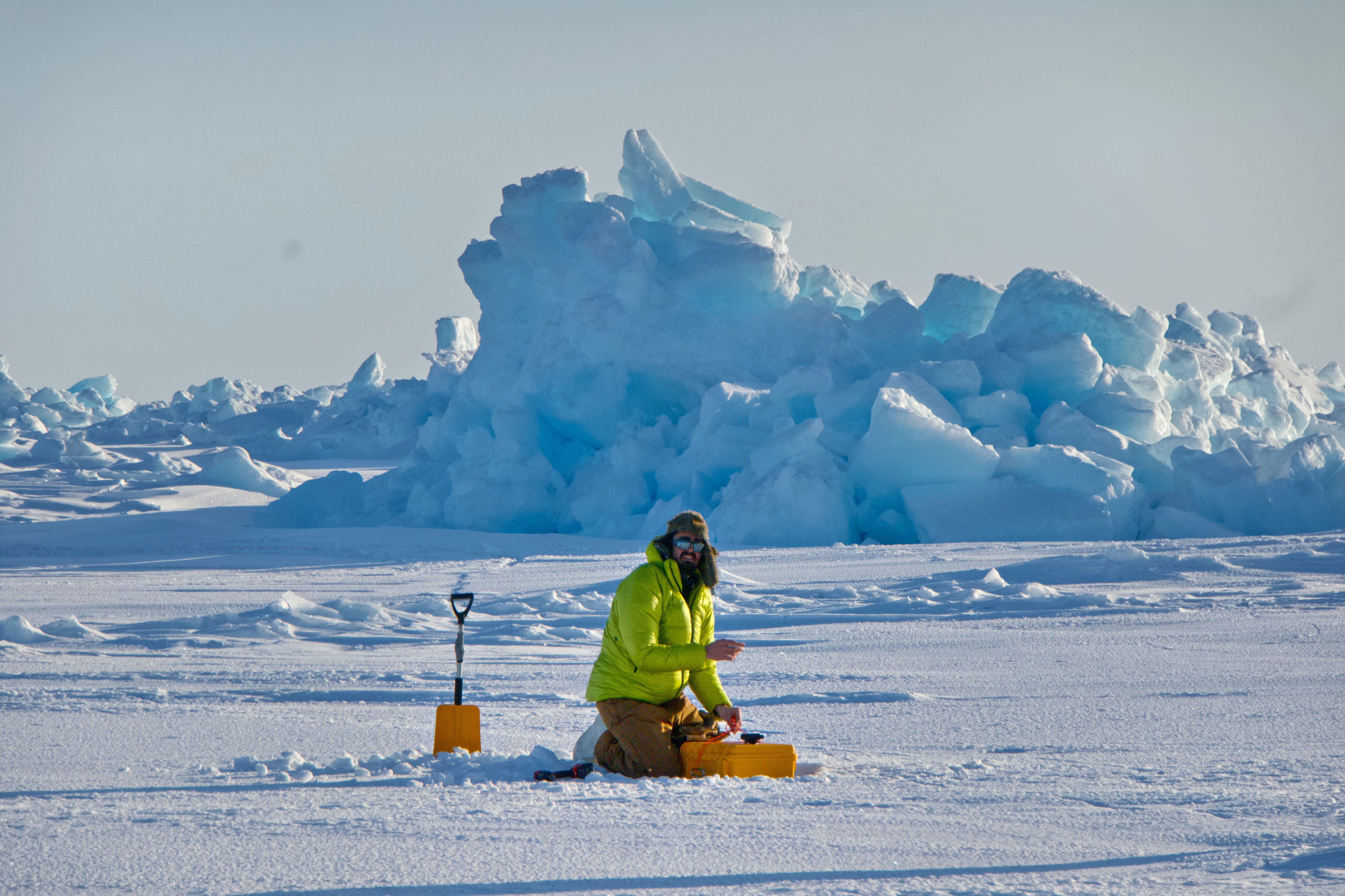 Achille Capelli installing a sensor on the ice floe in Alaska.