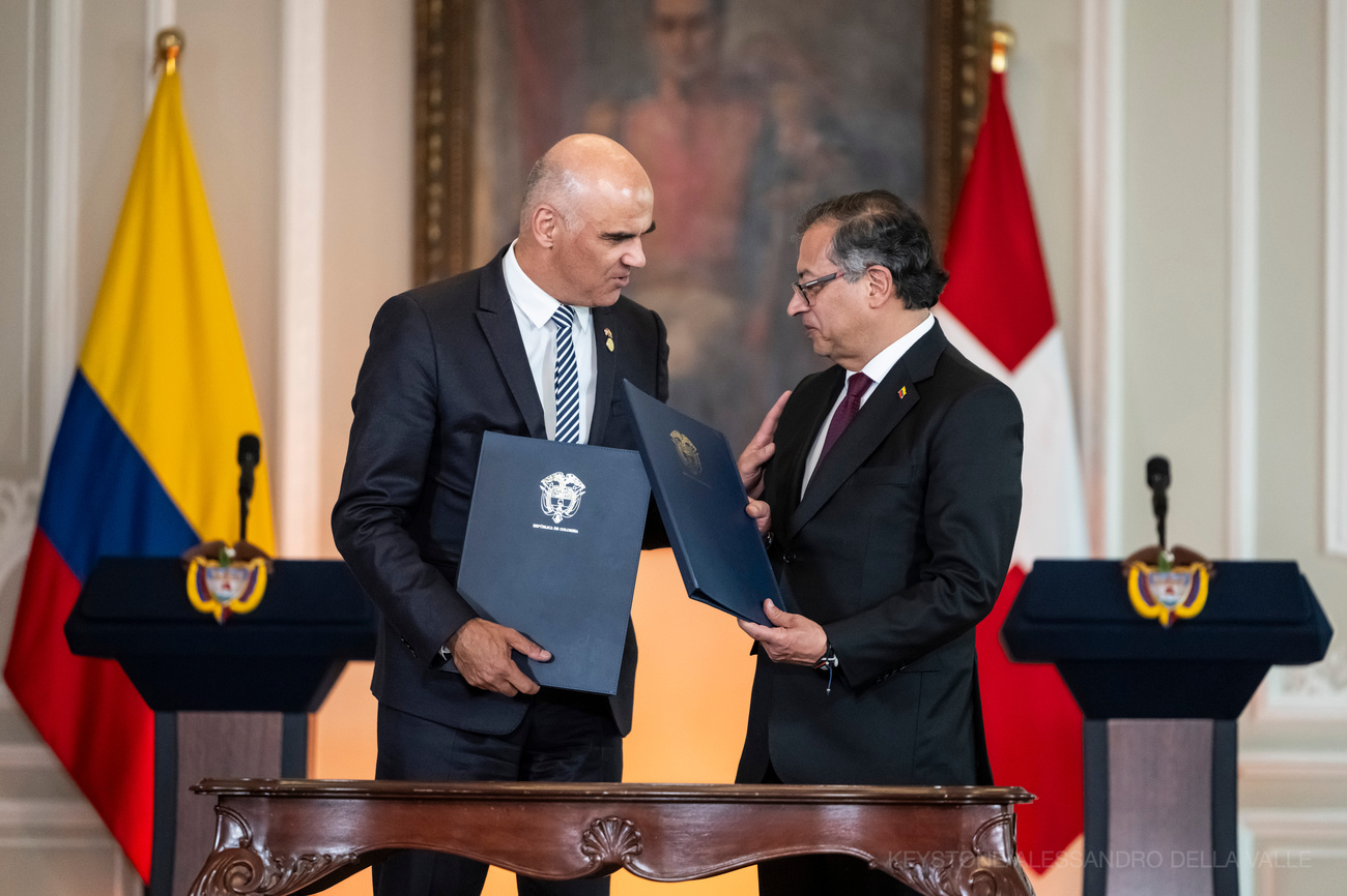 Gustavo Petro, president of Colombia, right, and Swiss President Alain Berset exchange the signed bilateral agreement for the preservation of a digital backup copy of the archives of the Colombian truth commission in Switzerland on August 10, 2023 in Bogota, Colombia.