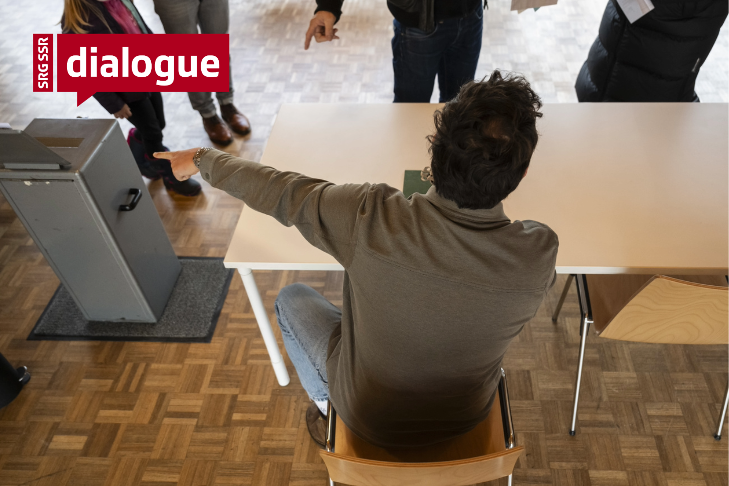 A citizen on polling duty directs the voters at the polling station