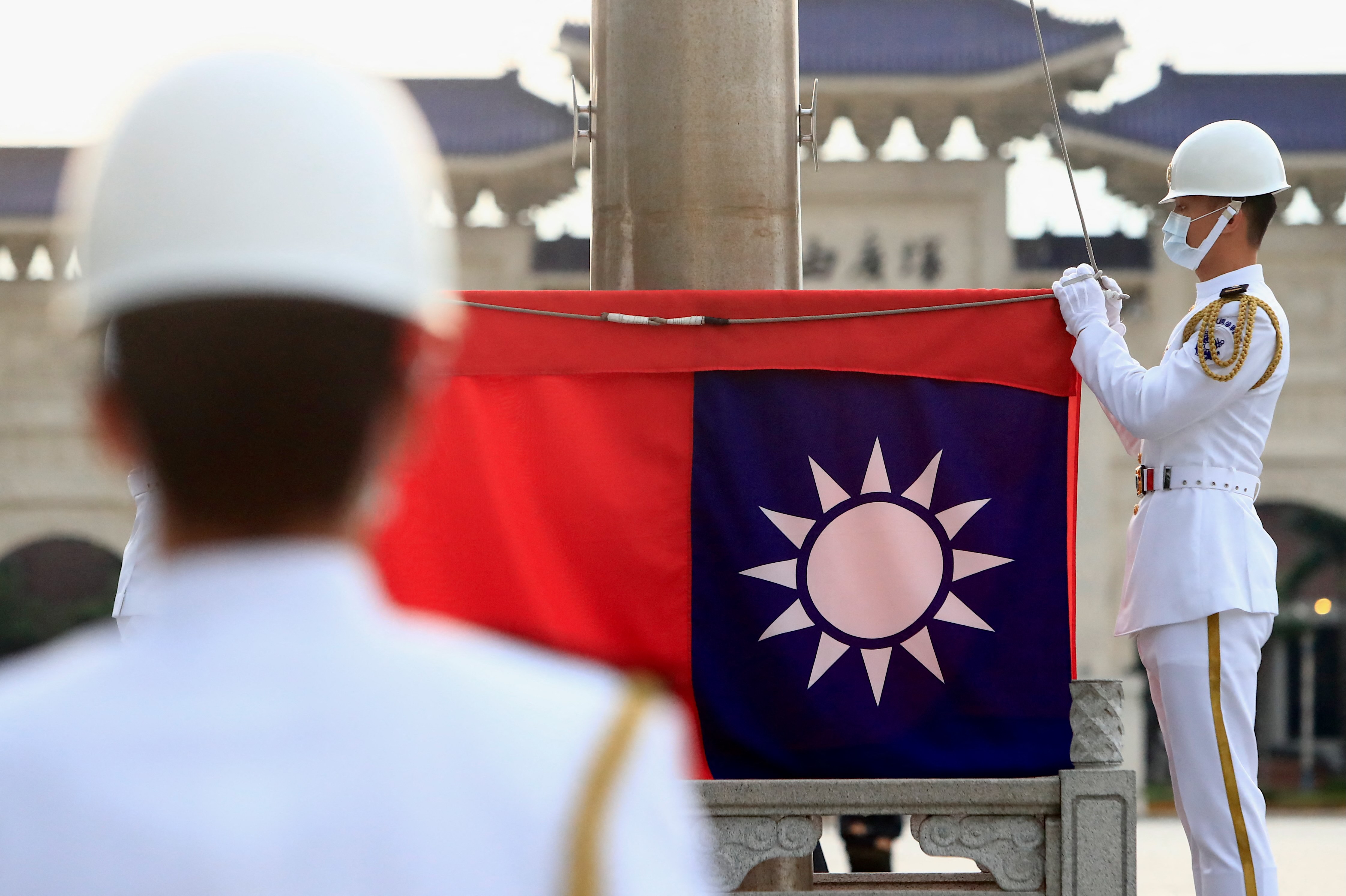 Taiwanese honor guards hold a Taiwan flag at Liberty Square, amid a surge of domestic COVID-19 cases and the rising Taiwan-China tensions, in Taipei, Taiwan, 23 May 2021.