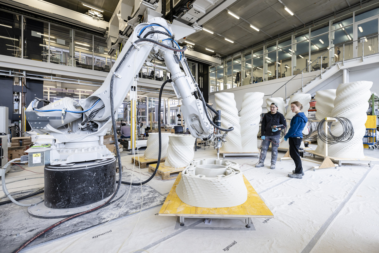 The 3D printer is actually a robotic arm with a nozzle through which the concrete mixture can be printed.