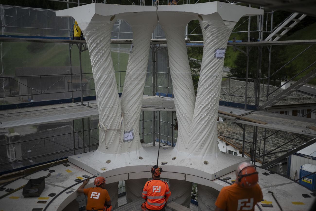 Workers fix the double columns floor by floor.