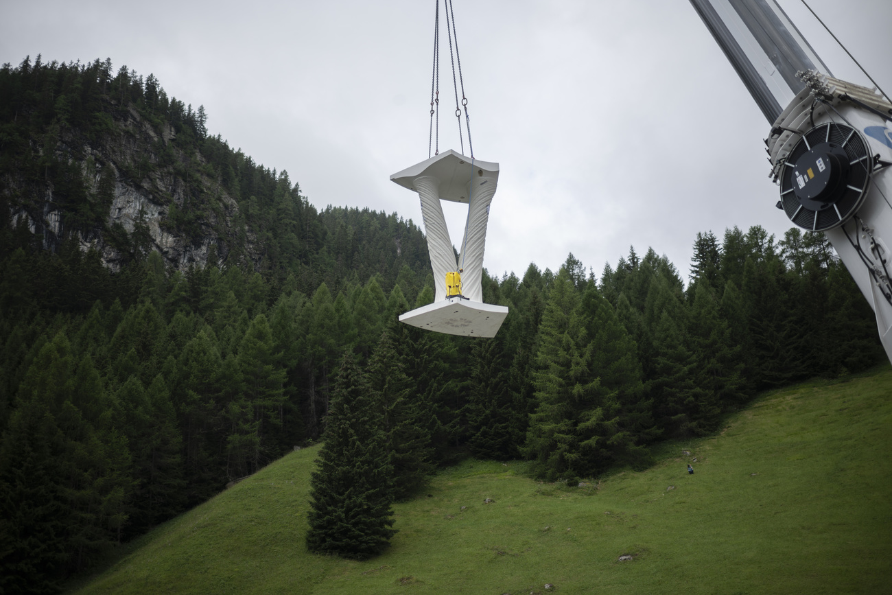 One of the pillars for the White Tower is lifted into position by crane.
