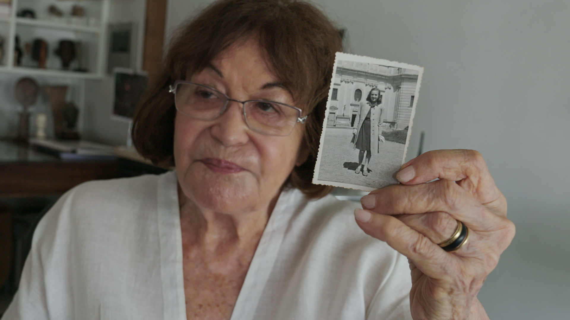 Claudia Andujar shows a picture of herself as a young woman, in the 1940s.