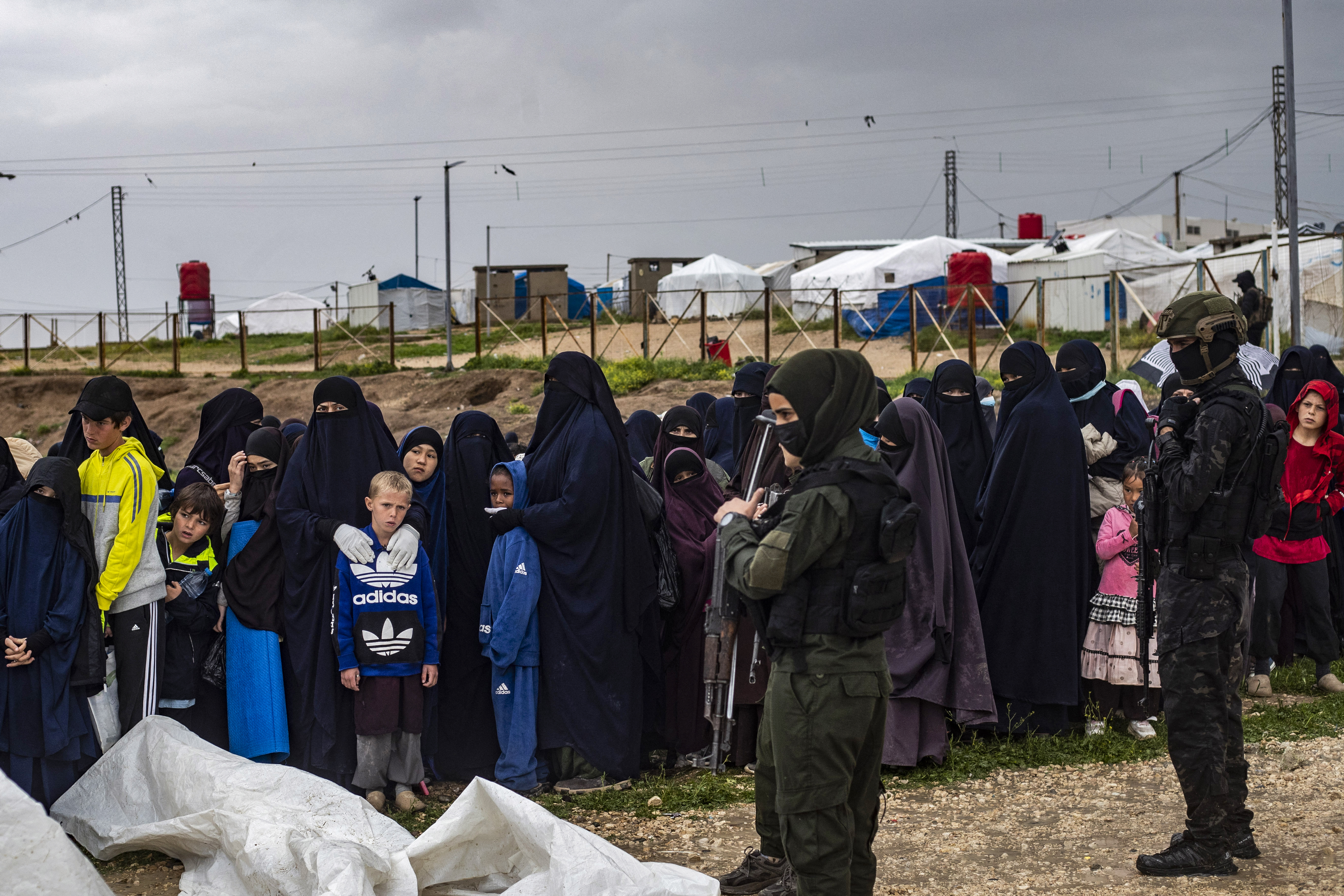Women and children queue during a joint security operation by Syria's Kurdish Internal Security Police Force and the Kurdish-led Syrian Democratic Forces (SDF) at Camp Roj, Syria.