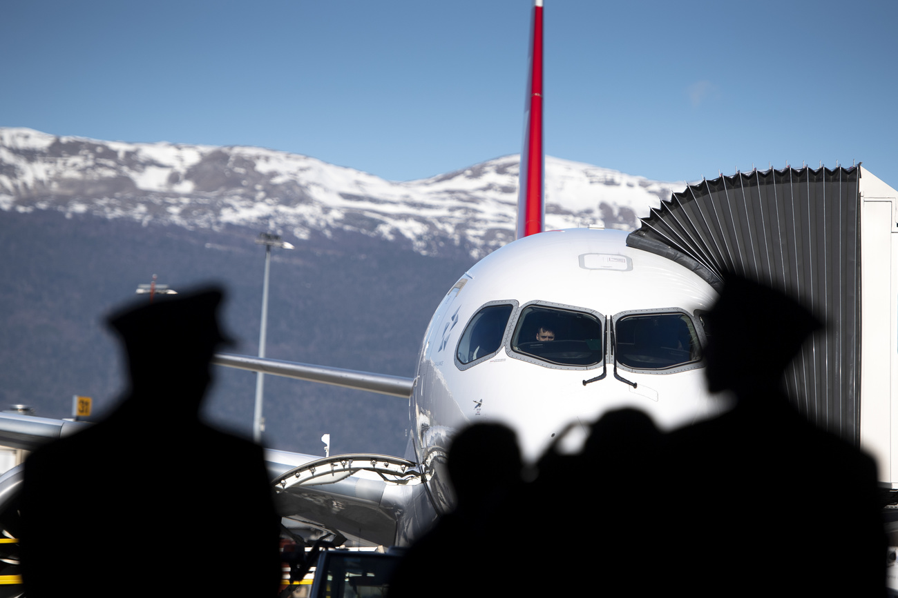 equipaggio pilota e hostess aspettano davanti a un aereo in pista