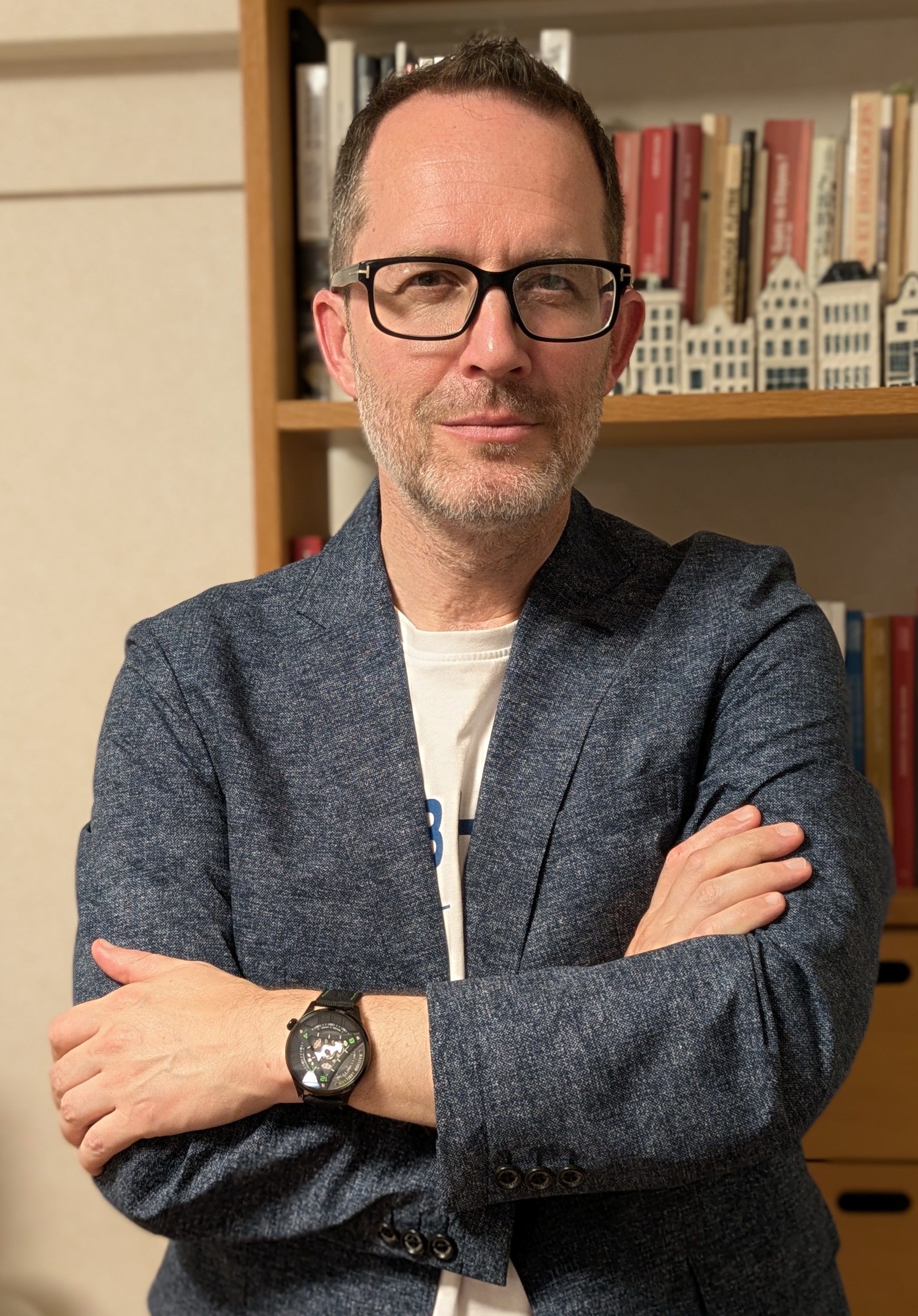 man in front of bookshelf