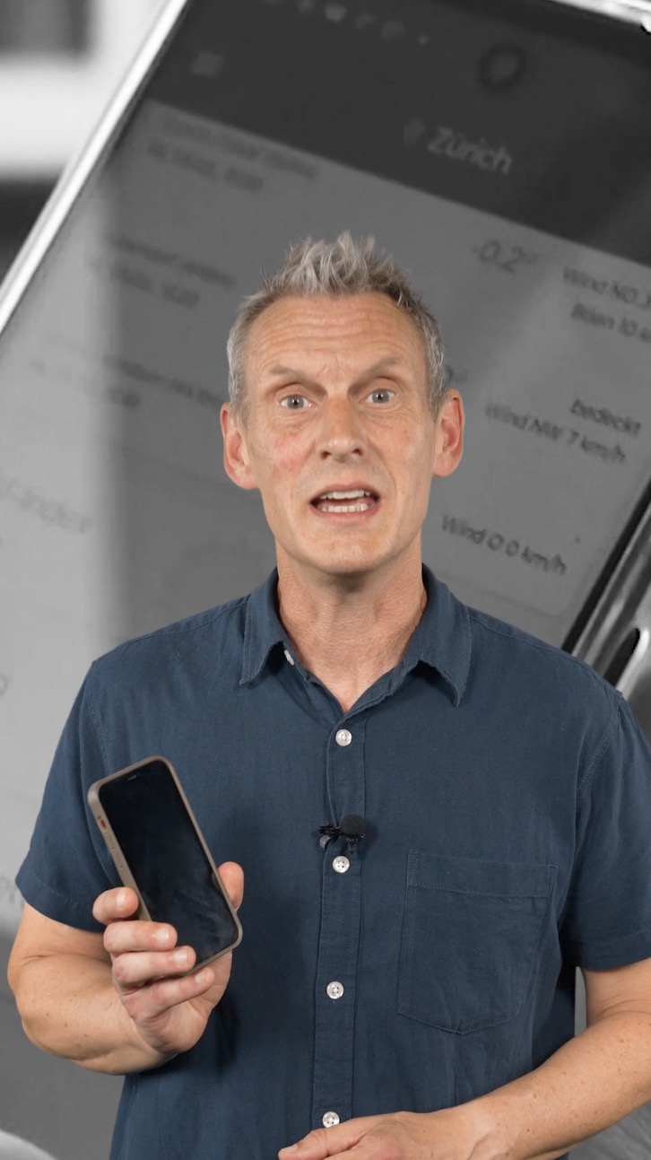 A man standing in front of an image of a smartphone