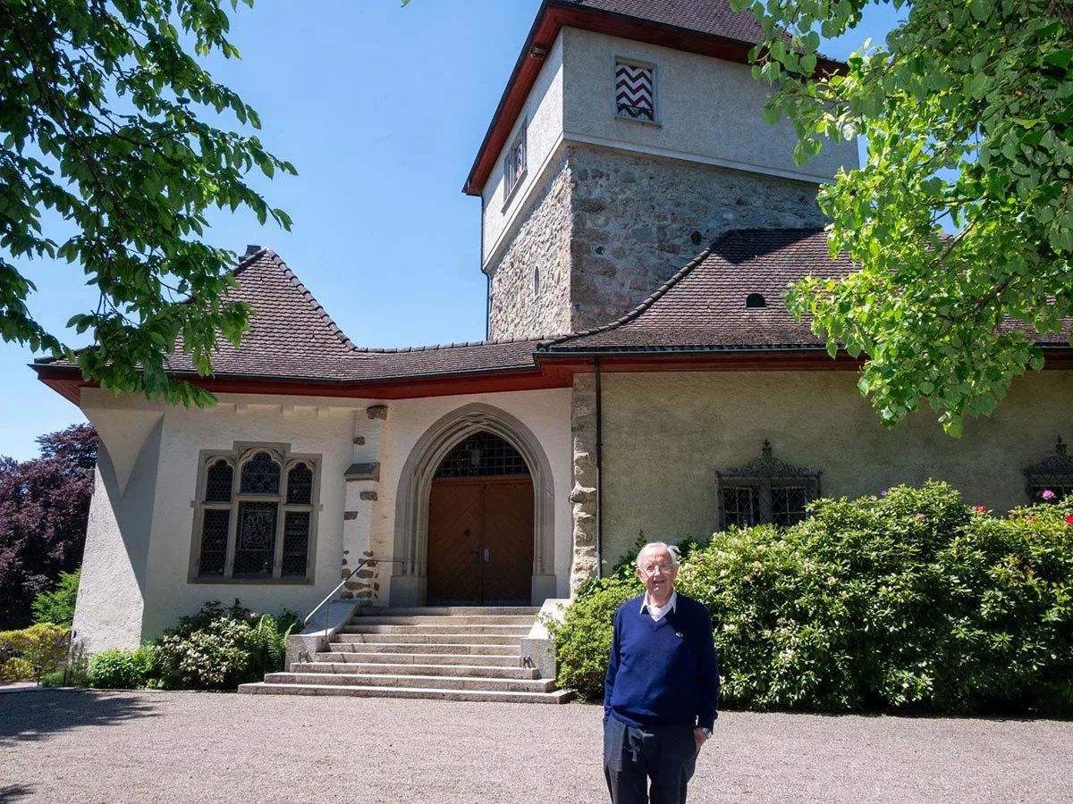 man standing in front of small castle